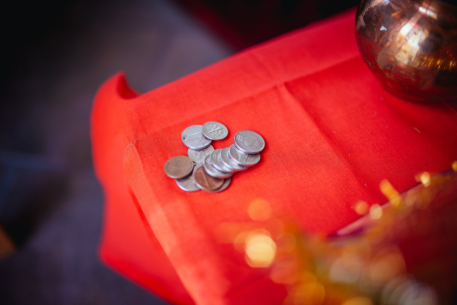 Coins on a red table cloth at Richmond VA Indian wedding Shawnee Custalow photography
