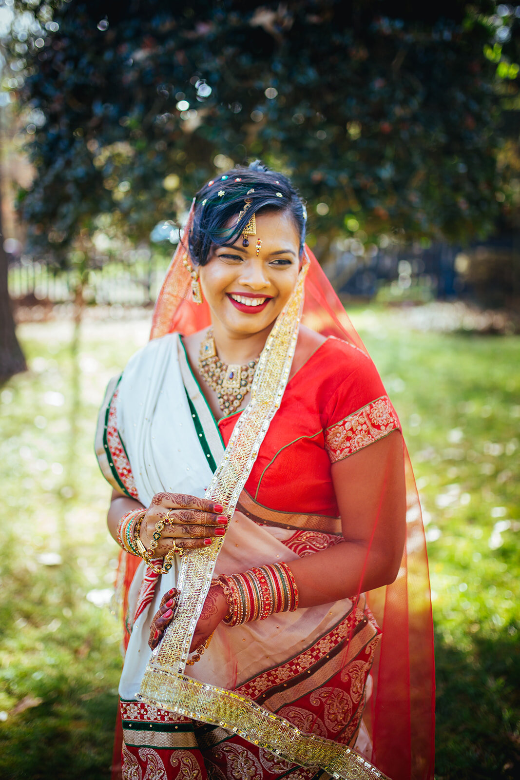 Indian Bride holding veil in Richmond VA Shawnee Custalow queer wedding photographer