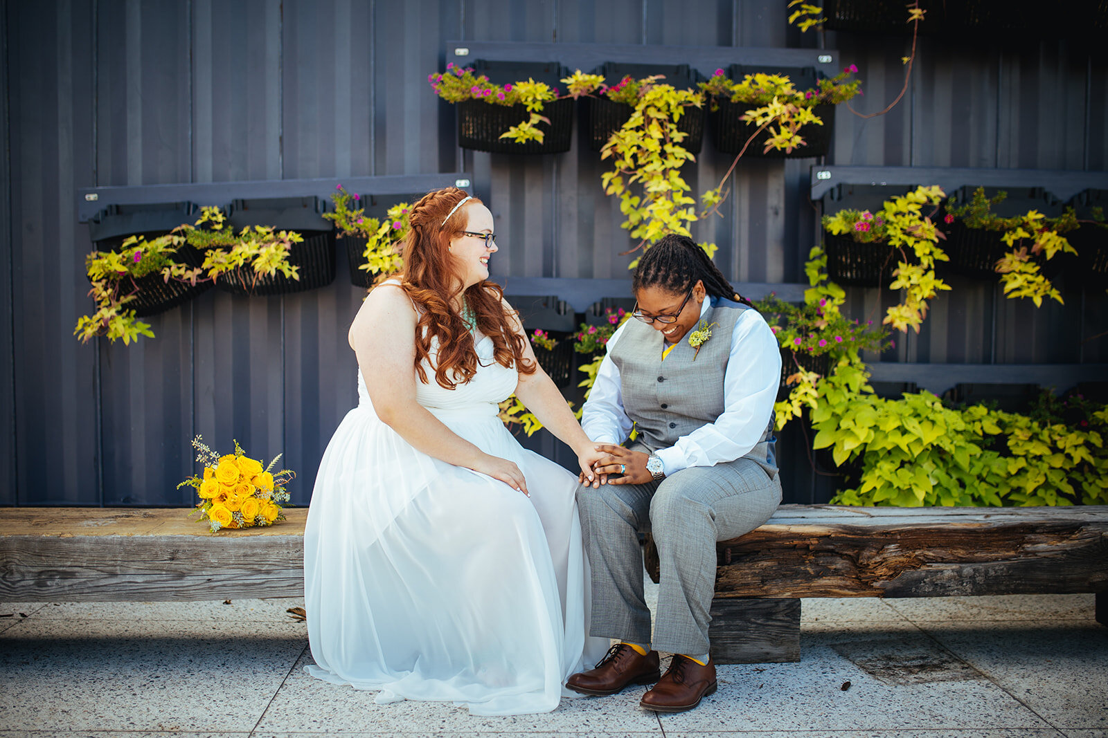 LGBTQ newlyweds sitting in the arts district in Norfolk VA Shawnee Custalow wedding photography