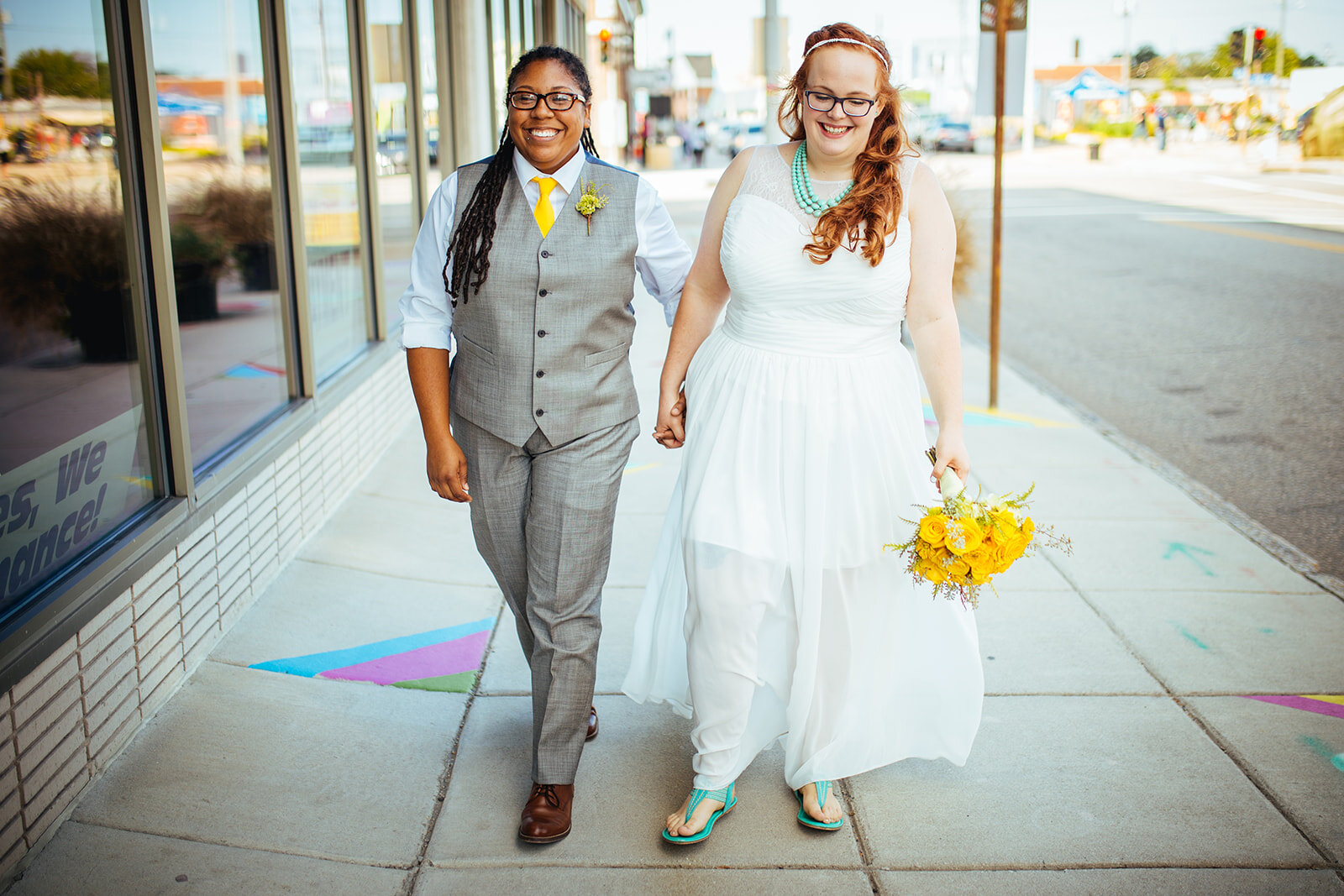 Queer couple holding hands walking through in Norfolk VA Shawnee Custalow wedding photography
