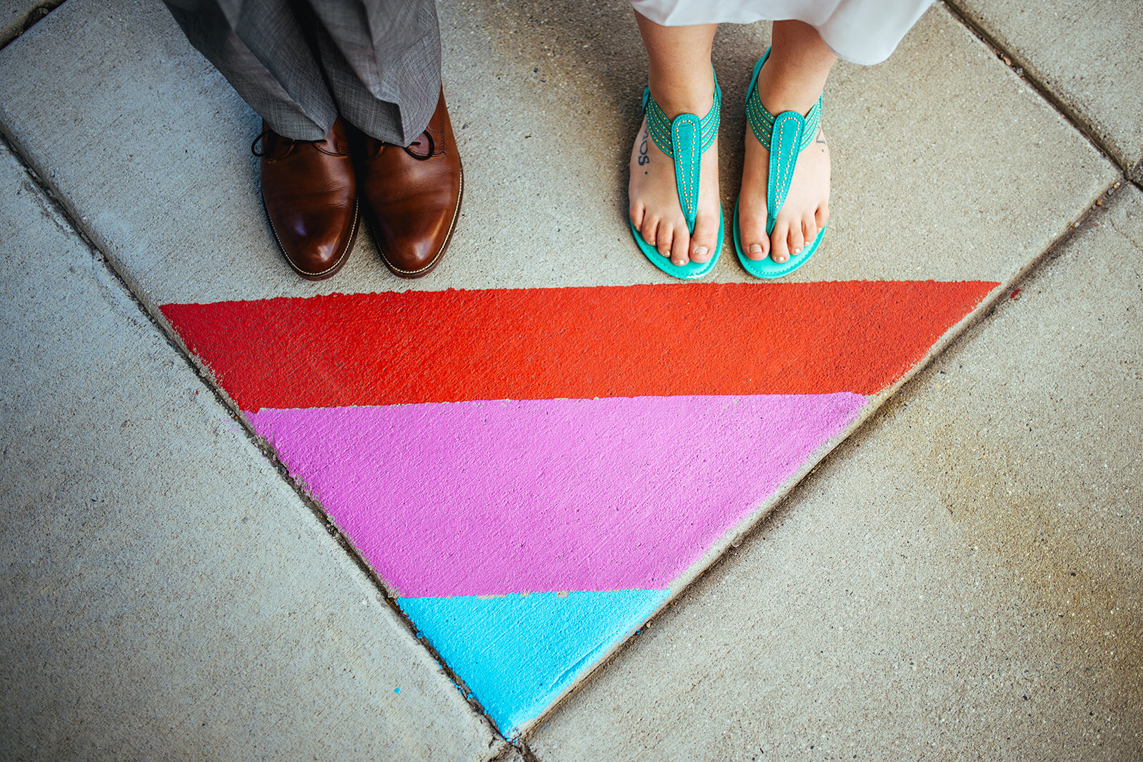 Newlyweds shoes by painted sidewalk in Norfolk VA Shawnee Custalow wedding photography