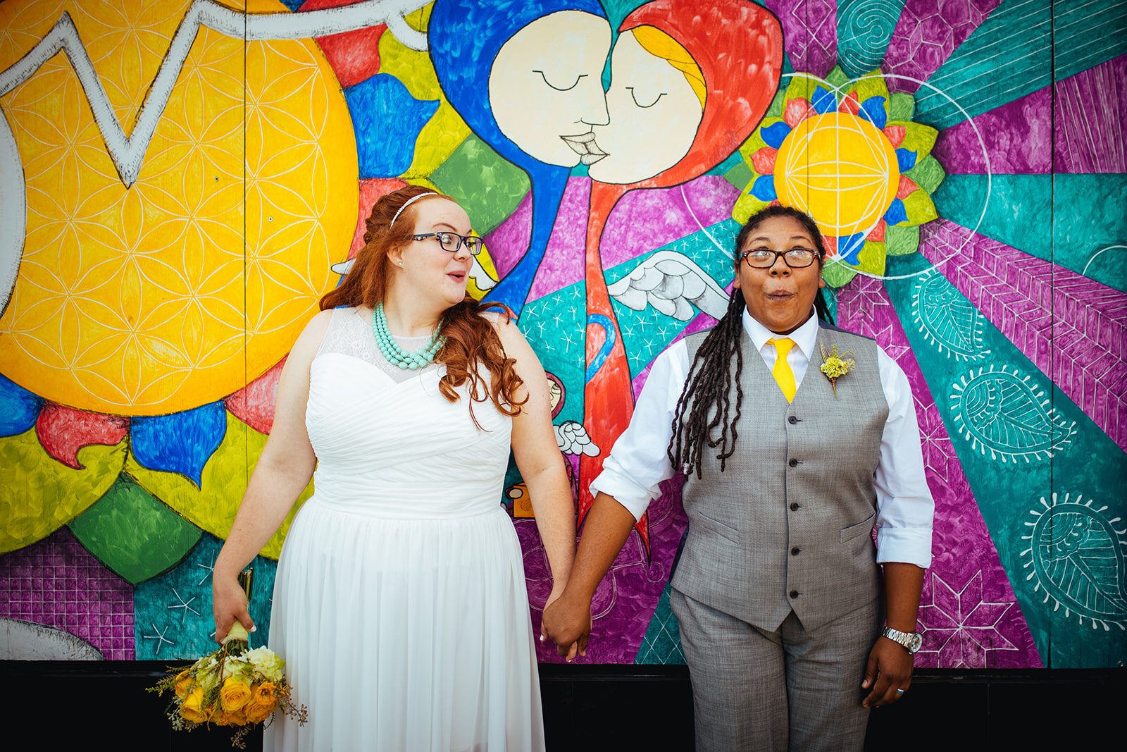 Newlyweds making silly faces by a mural in Norfolk VA Shawnee Custalow wedding photography