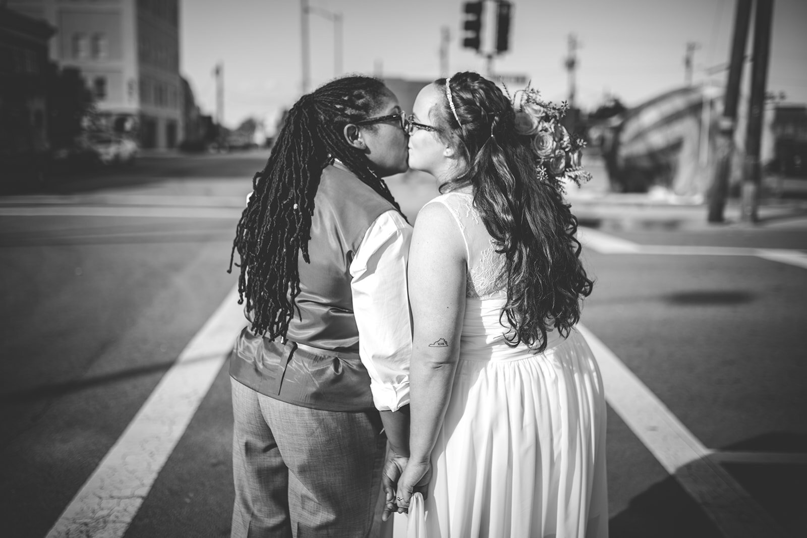 LGBTQ newlyweds kissing in Norfolk Arts district VA Shawnee Custalow wedding photography