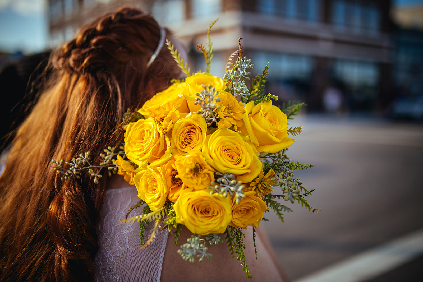 Newlywed holding a yellow bouqet in Norfolk VA Arts District Shawnee Custalow photography