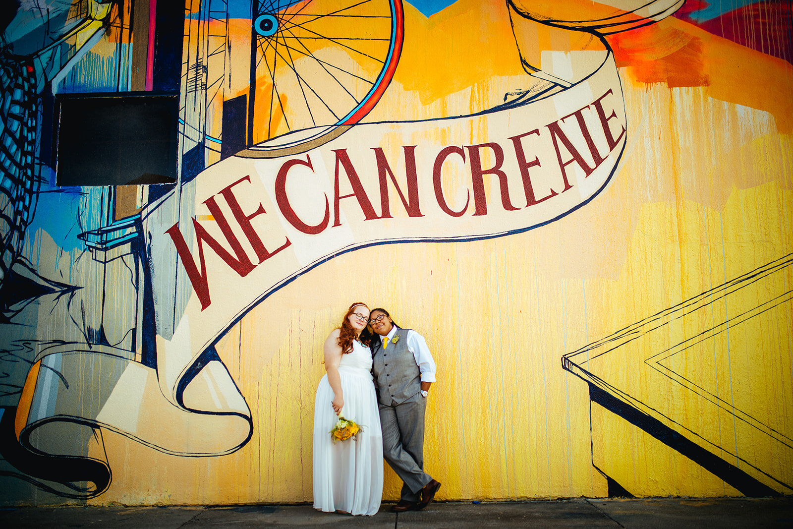 Newlyweds leaning together under a mural in Norfolk VA Shawnee Custalow photography