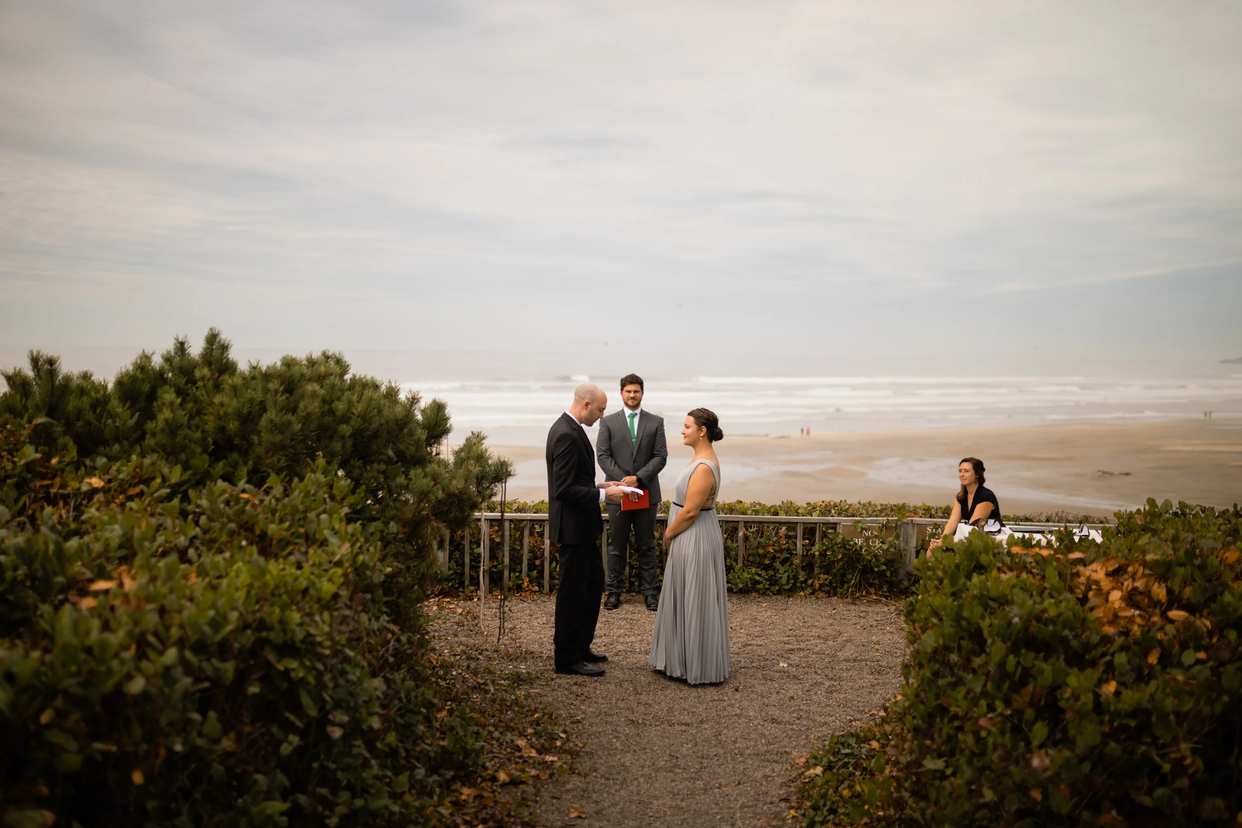 Wedding ceremony on the beach in Newport Oregon Shawnee Custalow Queer Wedding photographer