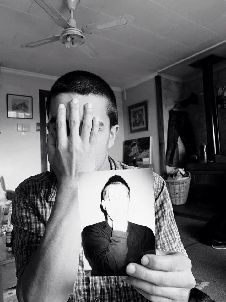 Our son holding a picture of his father.