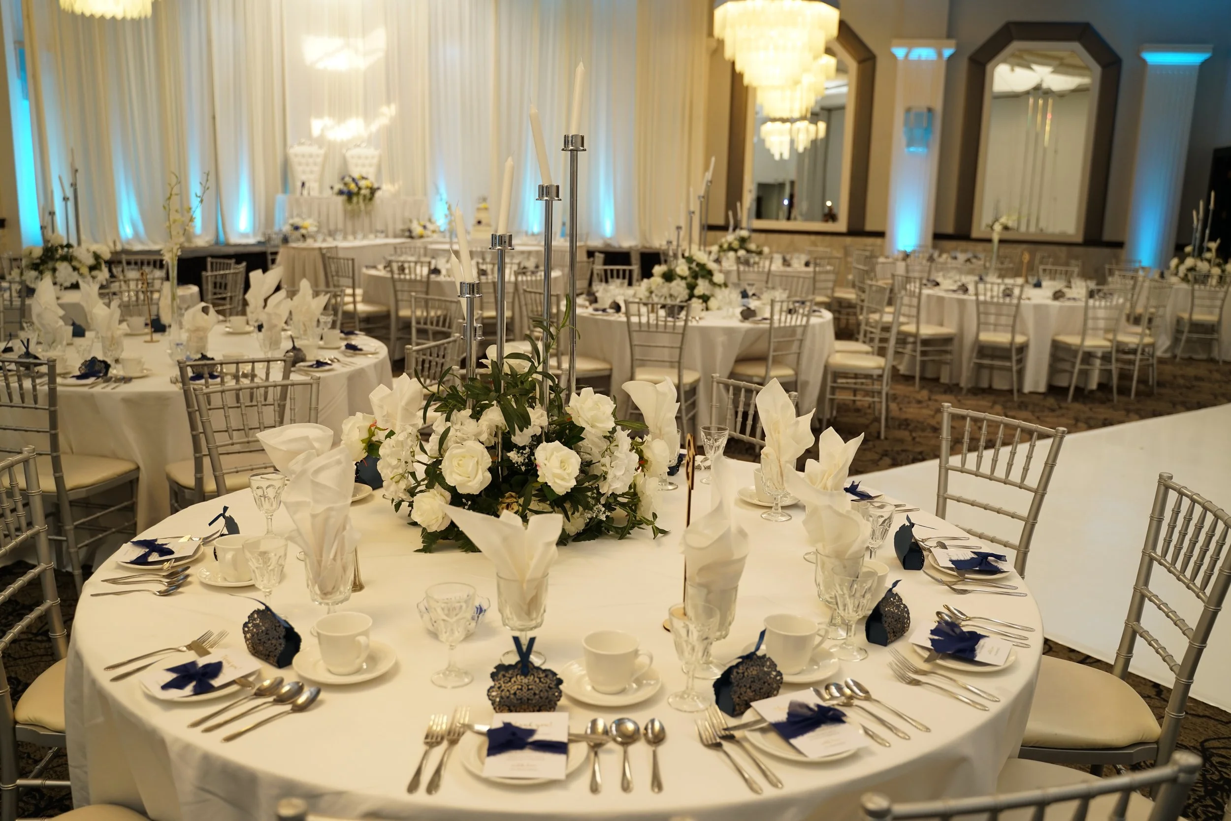 elegant white centerpieces, candleabras, reception room