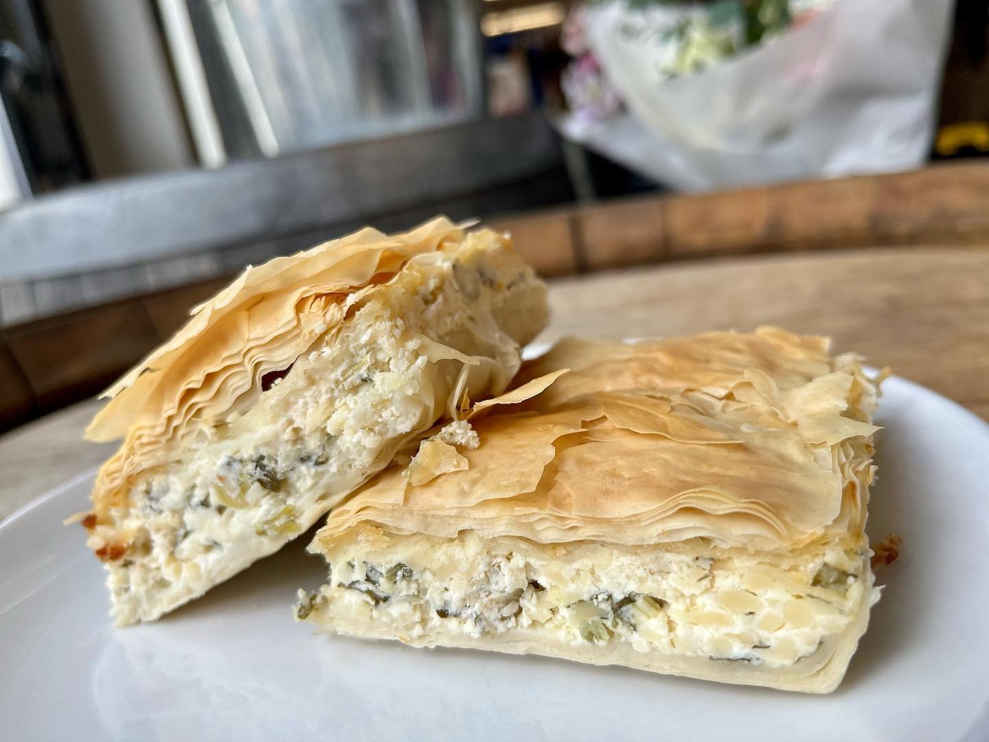 NEW deli item alert! 😋 This photogenic beauty  is none other than Tiropita- a decadent, creamy fan favorite Greek pastry! Made of crispy, flaky phyllo dough slathered in herbed cheese filling! Treat yourself to one of these Mediterranean marvels as 