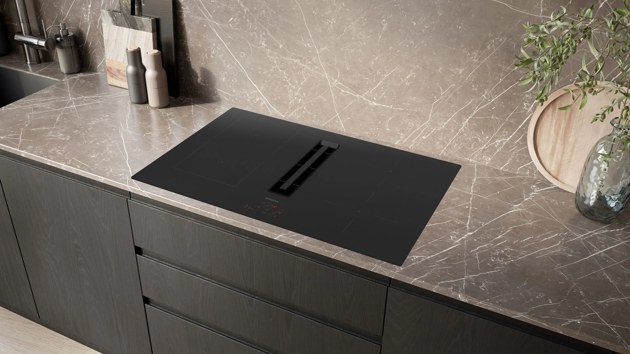 Siemens venting hob within a modern handle less kitchen featuring bespoke dark wood doors and thin 20mm quartz veined worktop.
