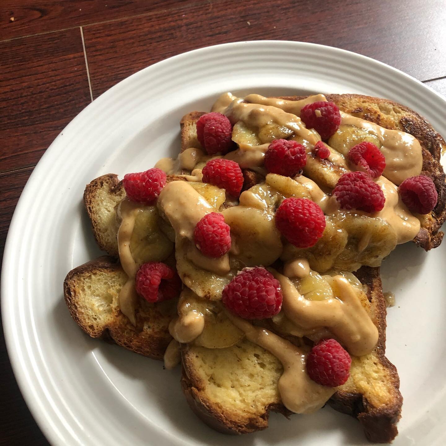 this mornins french toast brought to you by @bbirdco white pullman bread made by my dearest hila &hearts;️ topped w caramelized bananas, peanut butter sauce &amp; fresh raspberries!