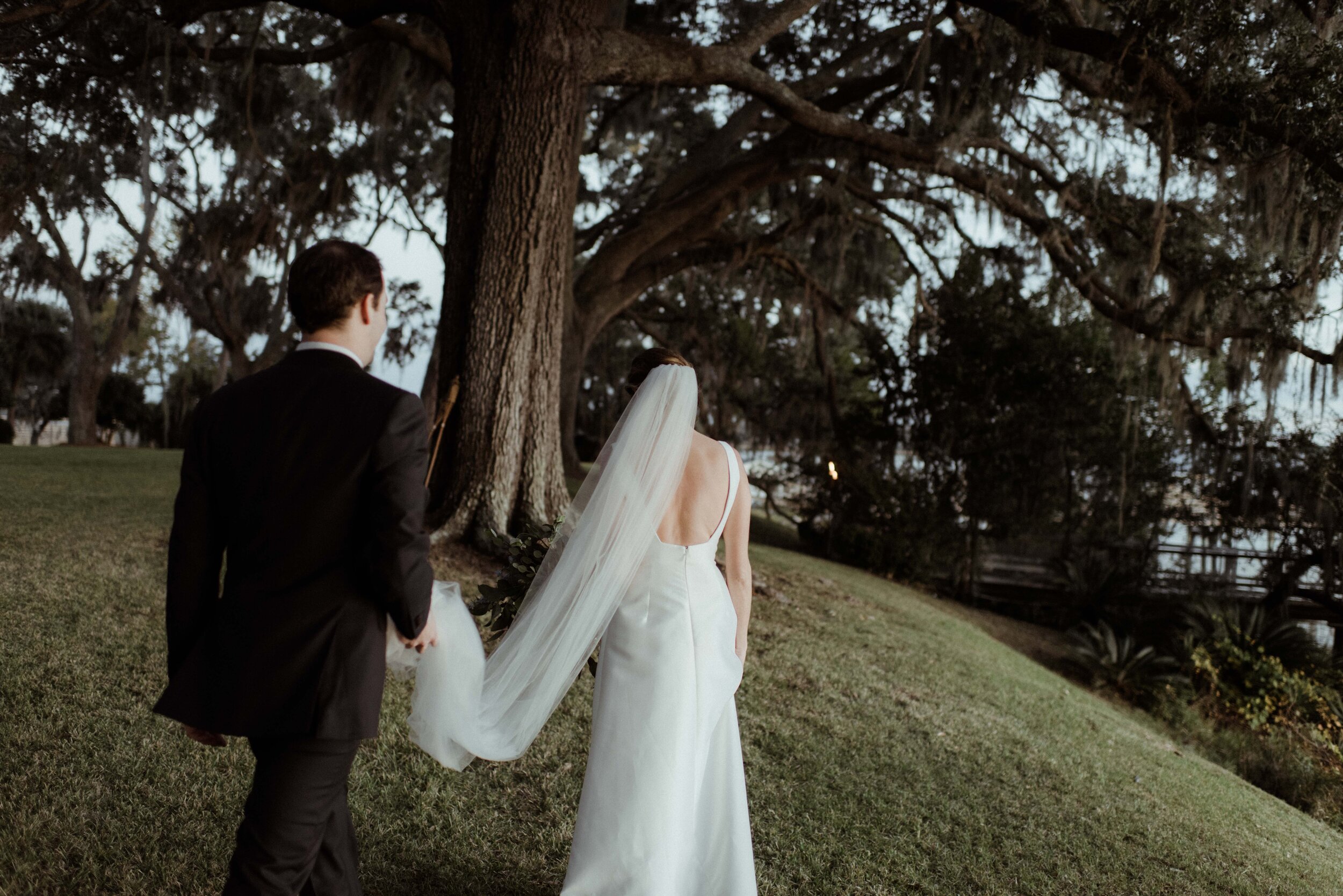 romantic-backyard-wedding-savannah-georgia-groom-carries-veil.jpg