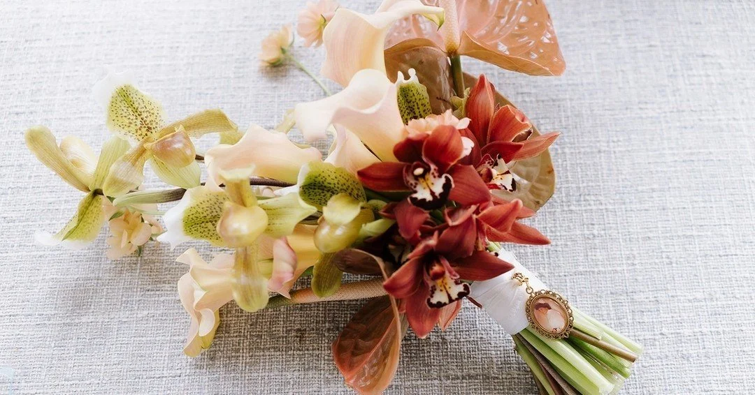 A modern bridal bouquet featuring calla lilies, cymbidium orchids, slipper orchids, and warm copper anthurium for a sculptural, fashion-forward look. Perfect inspiration for brides who love clean lines, contemporary florals, and a sophisticated neutr