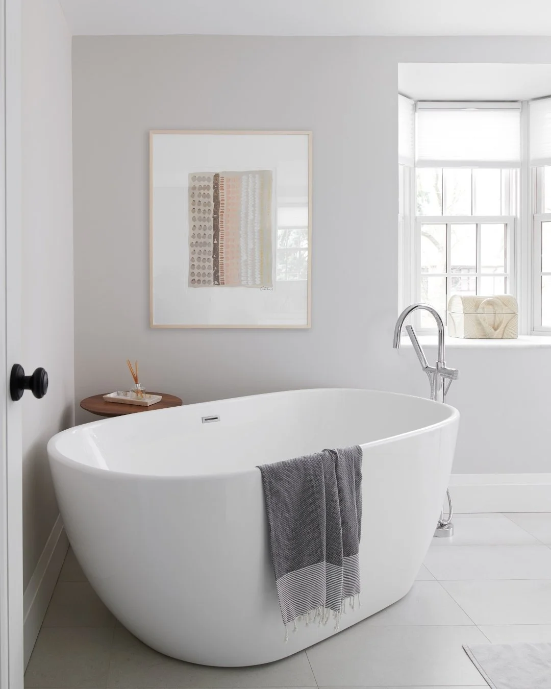 Designing this bathroom was all about finding that sweet spot between formality and flow. She loved a touch of tradition; he wanted modern simplicity. 

The freestanding tub became our happy medium &mdash; elegant but unfussy. Paired with sleek fixtu