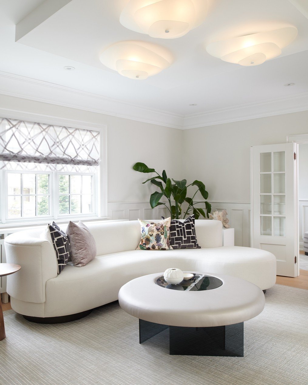 Suzanne and Andrew wanted a living room that felt light, inviting, and a little bit special &mdash; something formal enough for entertaining but still warm for everyday living. 

So we preserved the original panelling, modernized the fireplace, and p