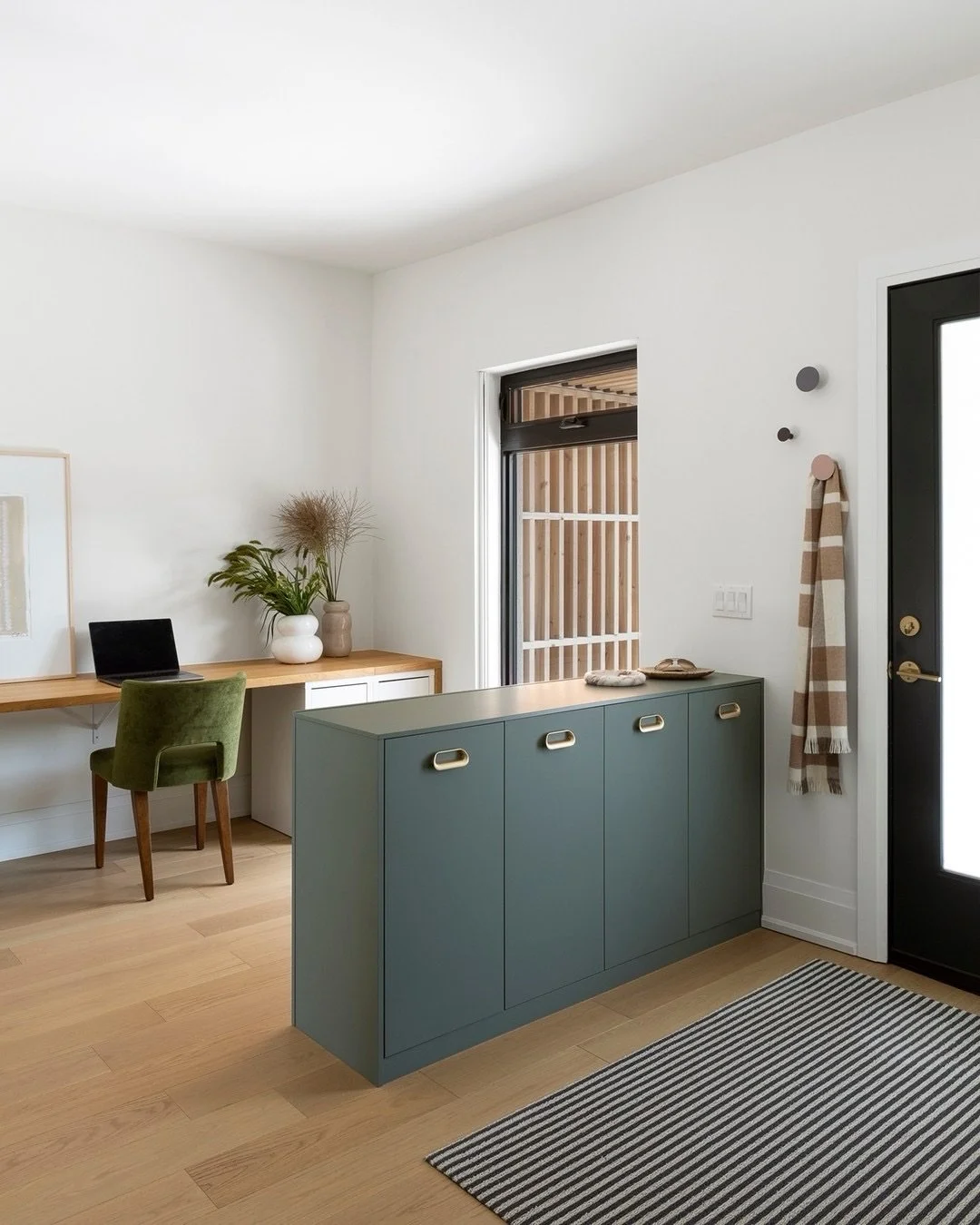 This space is a reminder that storage can be both practical and architectural. The teal cabinet is doing triple duty: extra storage, visual anchor, and a divider that gives the workspace a little privacy. 
⠀⠀⠀⠀⠀⠀⠀⠀⠀
Meanwhile, the tall mirrored close