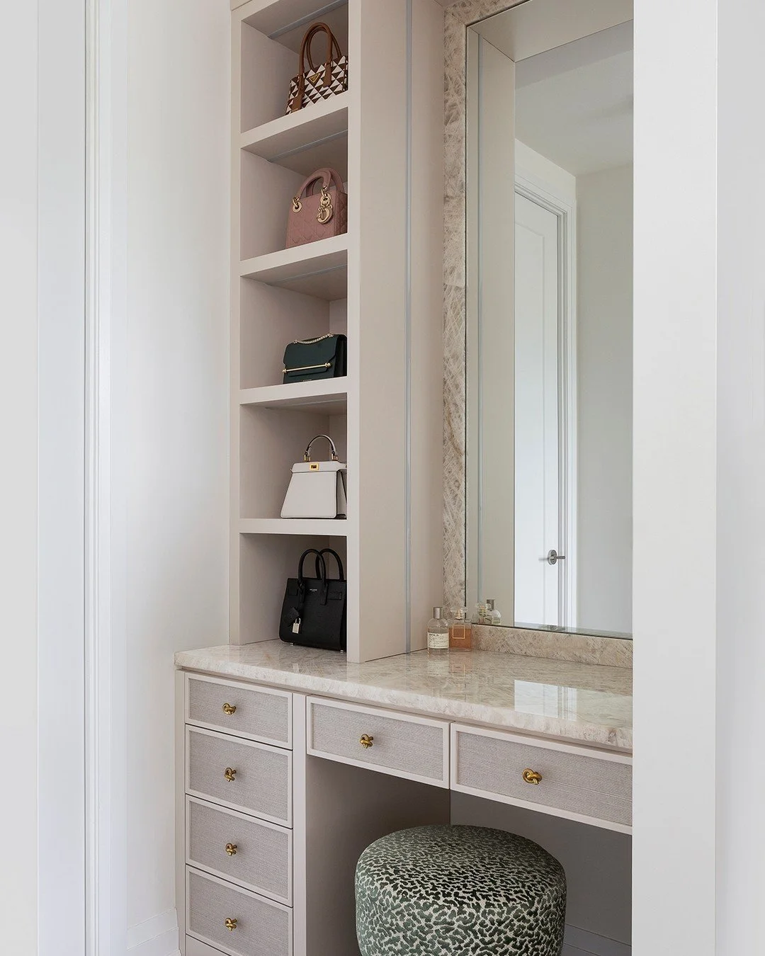 One light source is almost never enough in a getting-ready space.

Overhead lights flatten everything.
Mirror lights alone can feel too focused.
And without shelf lighting, display items disappear.

So we layered it. Lighting inside the shelves to hi
