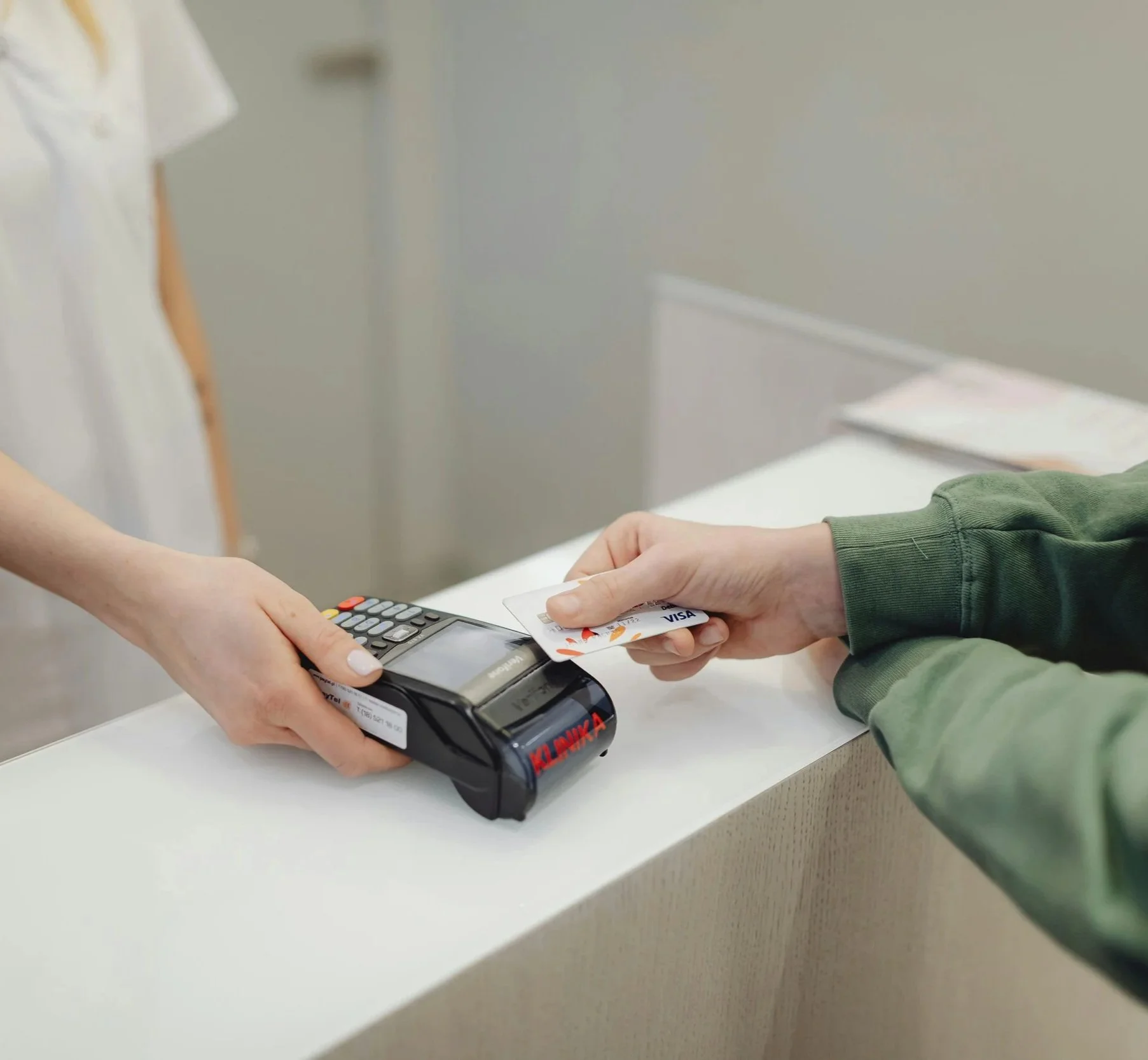 A person paying for a medical procedure with a credit card.