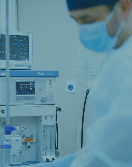 A blue tinted photo of a maske up doctor in a surgery room.