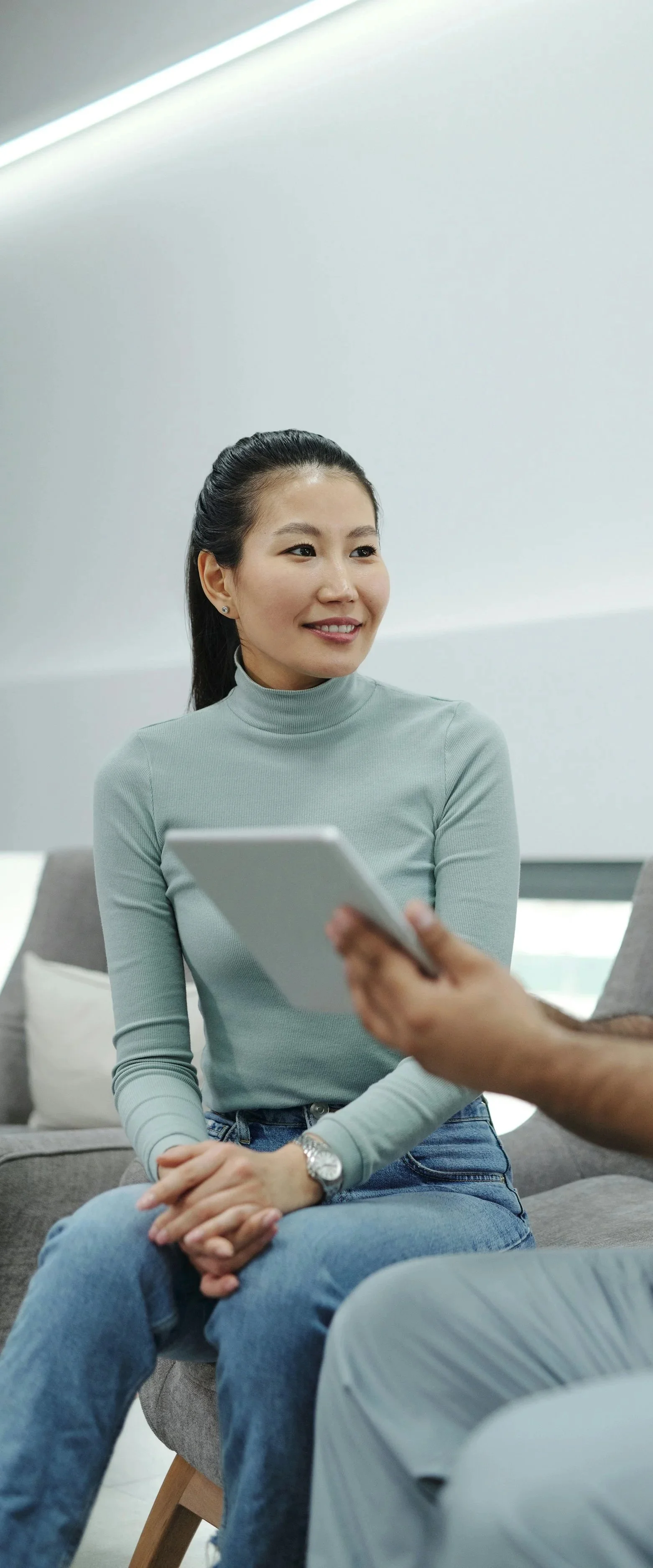 Photo of a smiling woman in a clinical setting.