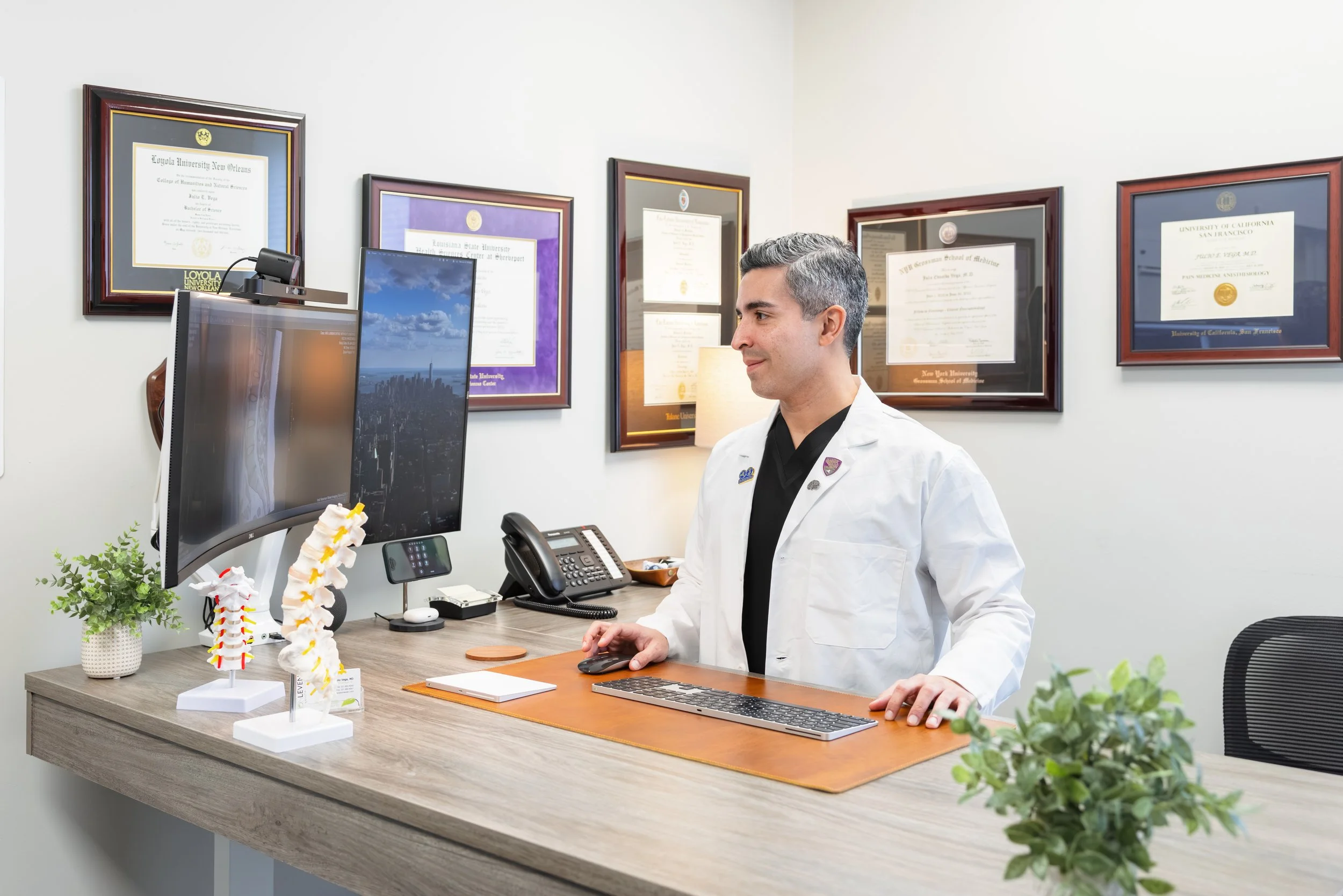A photo of BonLeven's Dr. Julio Vega working in his office.