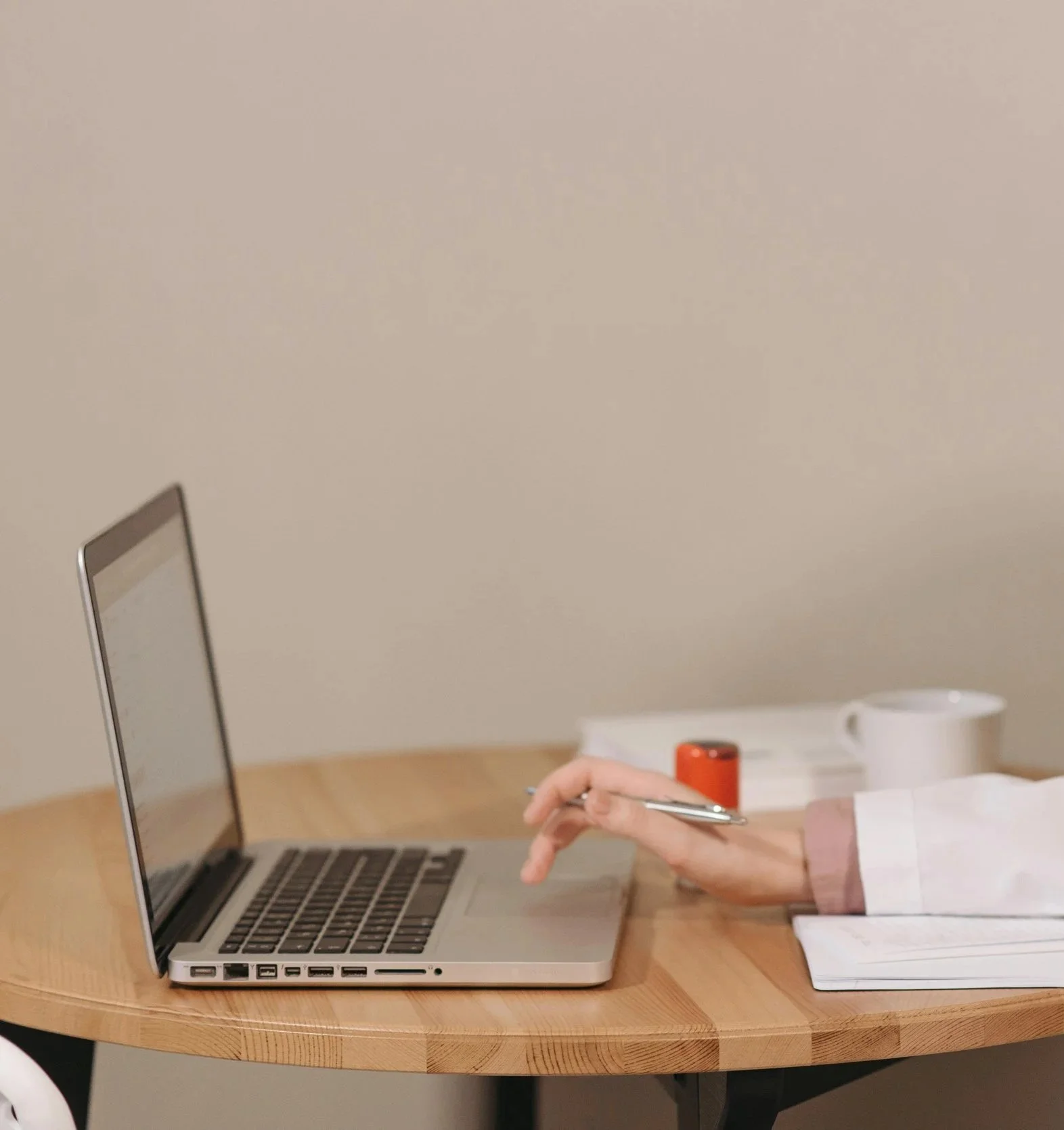 A doctor typing notes on a laptop.