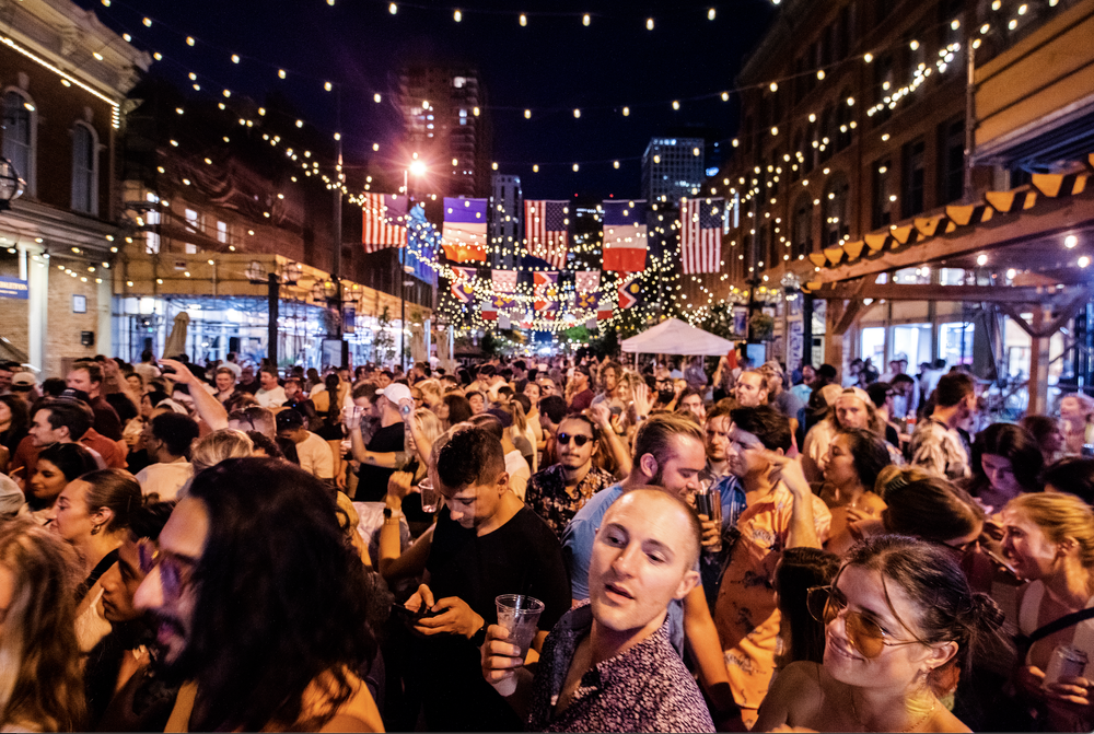  Crowds gather during Grammy-Award Winning DJ Cedric Gervais’ Taste of France set in July 2021 on Larimer Square.&nbsp; 