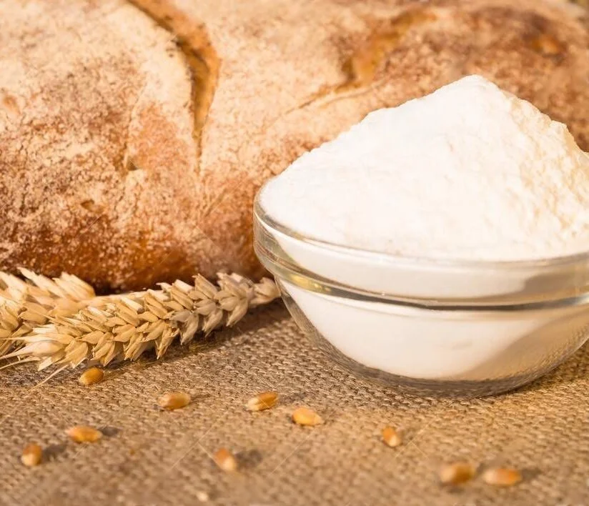 loaf-bread-lying-table-flour-dish-loaf-bread-lying-table-spikelets-wheat-flour-dish-against-101082340.jpg