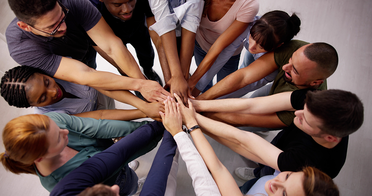 Stacked Hands with Group Visible 1200x633.png