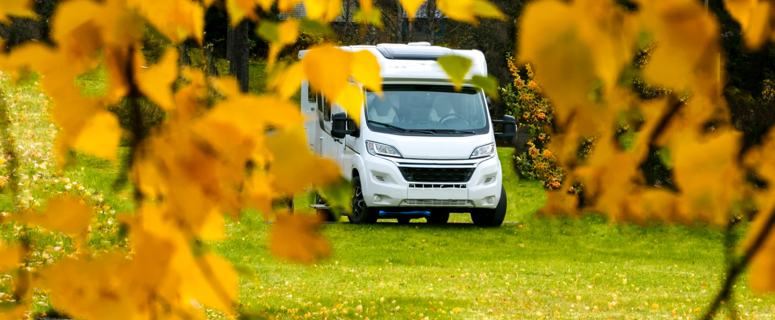 RV in Autumn Trees 2500x1500.png
