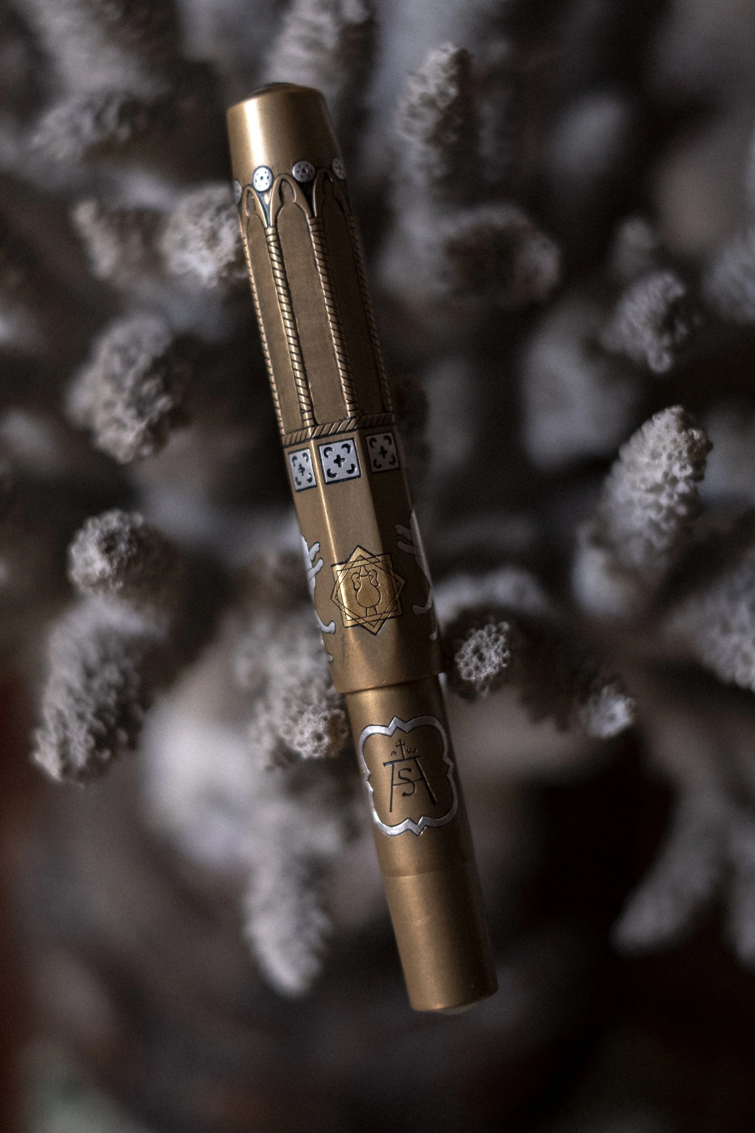A Kaweco Brass Sport fountain pen with gothic and romanesque style engravings inspired by sacred Florentine architecture. The pen is further embellished with inlaid silver, gold and copper detailing. 