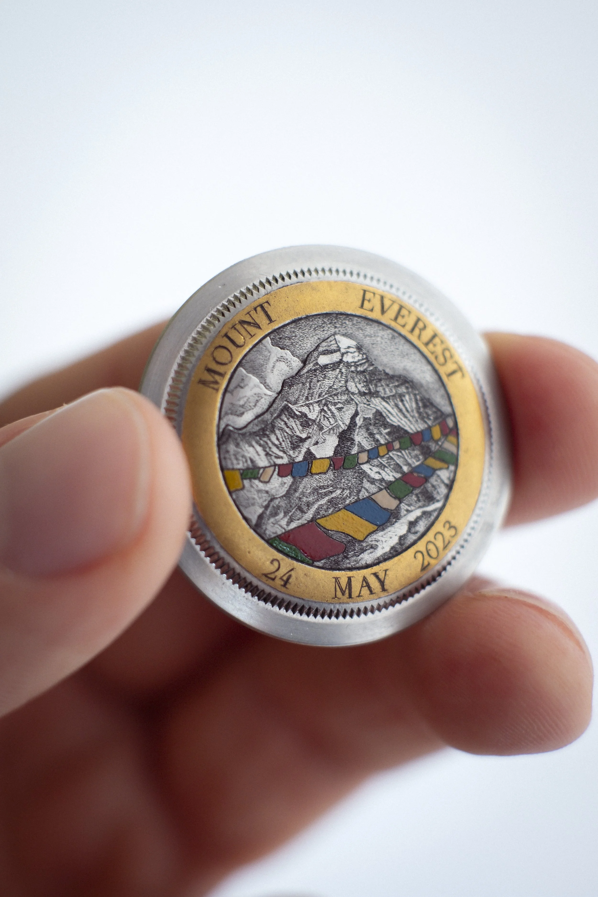 A commemorative engraving on the case back of a Rolex Explorer 1016 after the patron and owner of the watch wore it to summit Mt. Everest.  Mixed technique: surface engraving, sculpting, 24k gold inlay, and urushi lacquer. 
