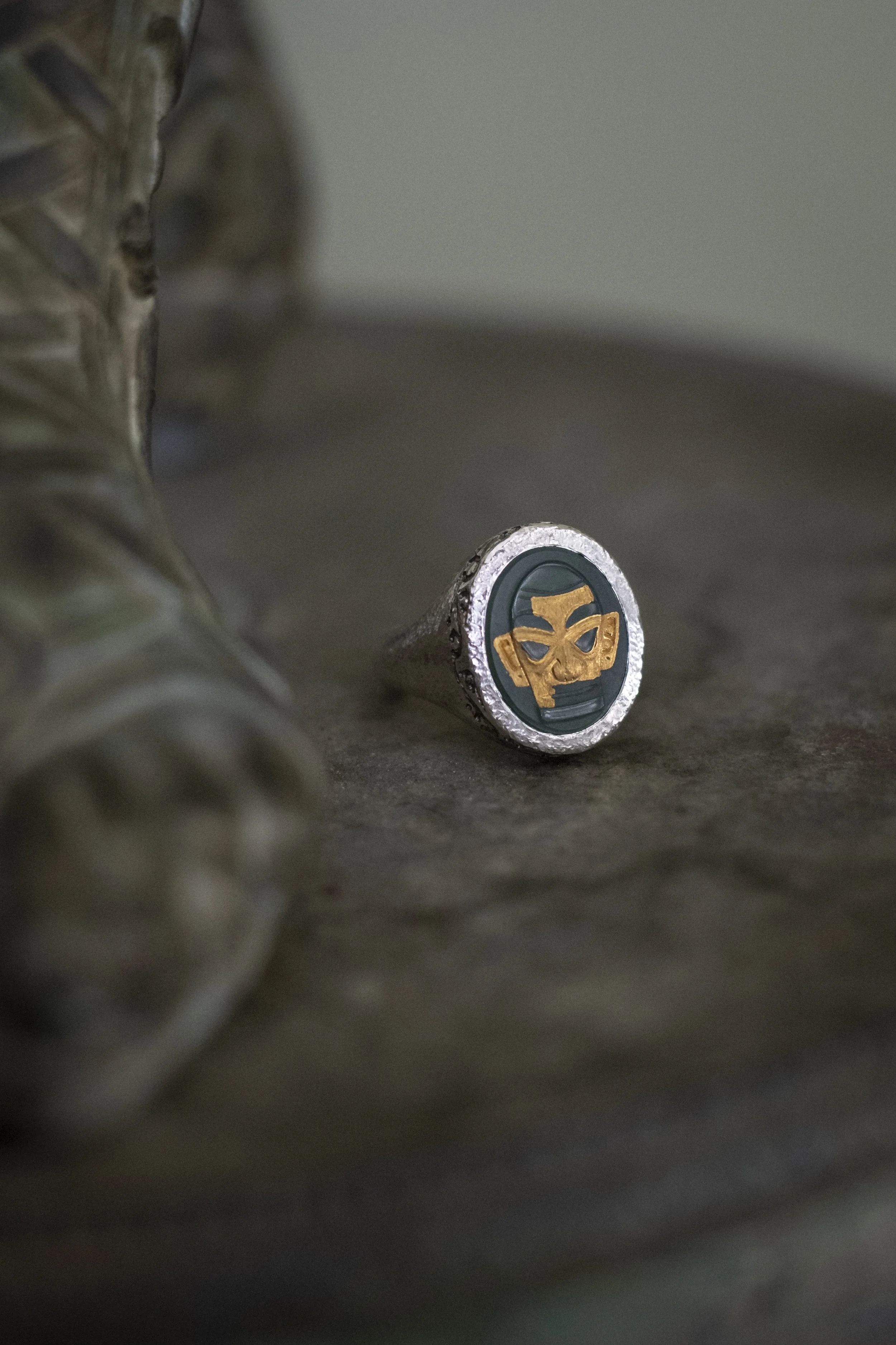 A hand carved jade cameo set in a sterling silver ring made in collaboration with Master Goldsmith Paolo Panko. The jade cameo depicts a gilt bronze figure from Sanxingdui, Sichuan province, China (ca. 1200-1050 BC); the gilding detail was accomplish