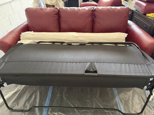 red leather sofa with mattress showing.jpeg