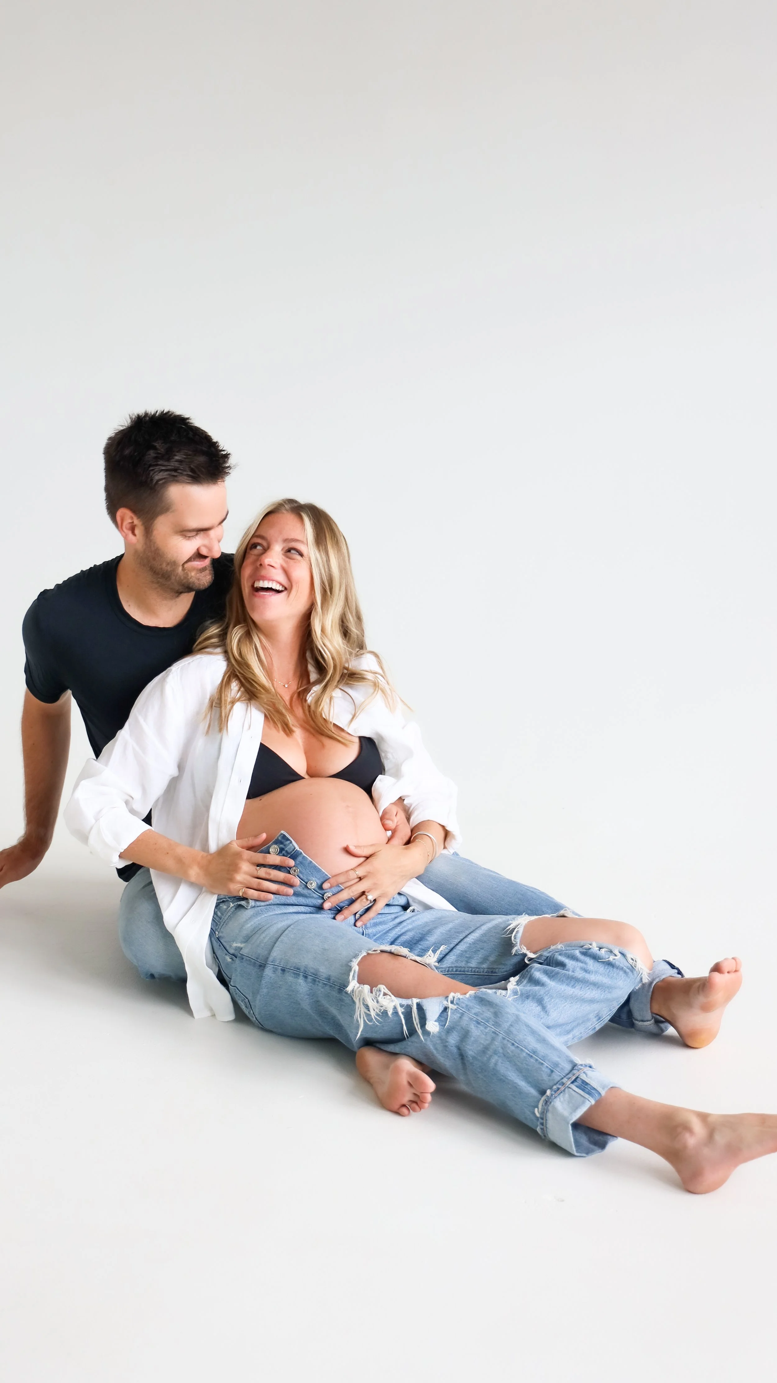 Celebrate the Middleton's journey into parenthood with stunning maternity photography at Realm Studio in Denver, CO, expertly captured by Nicole Schmiedl.