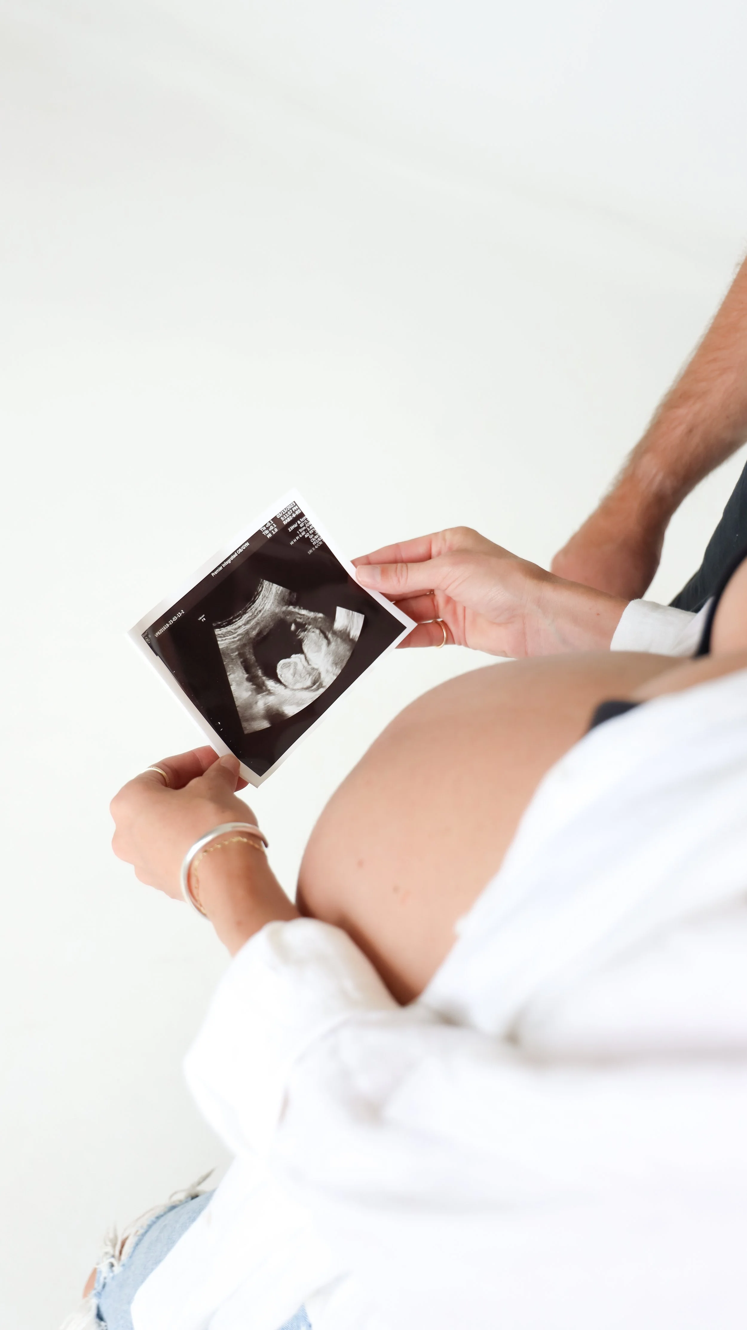 Celebrate the Middleton's journey into parenthood with stunning maternity photography at Realm Studio in Denver, CO, expertly captured by Nicole Schmiedl.