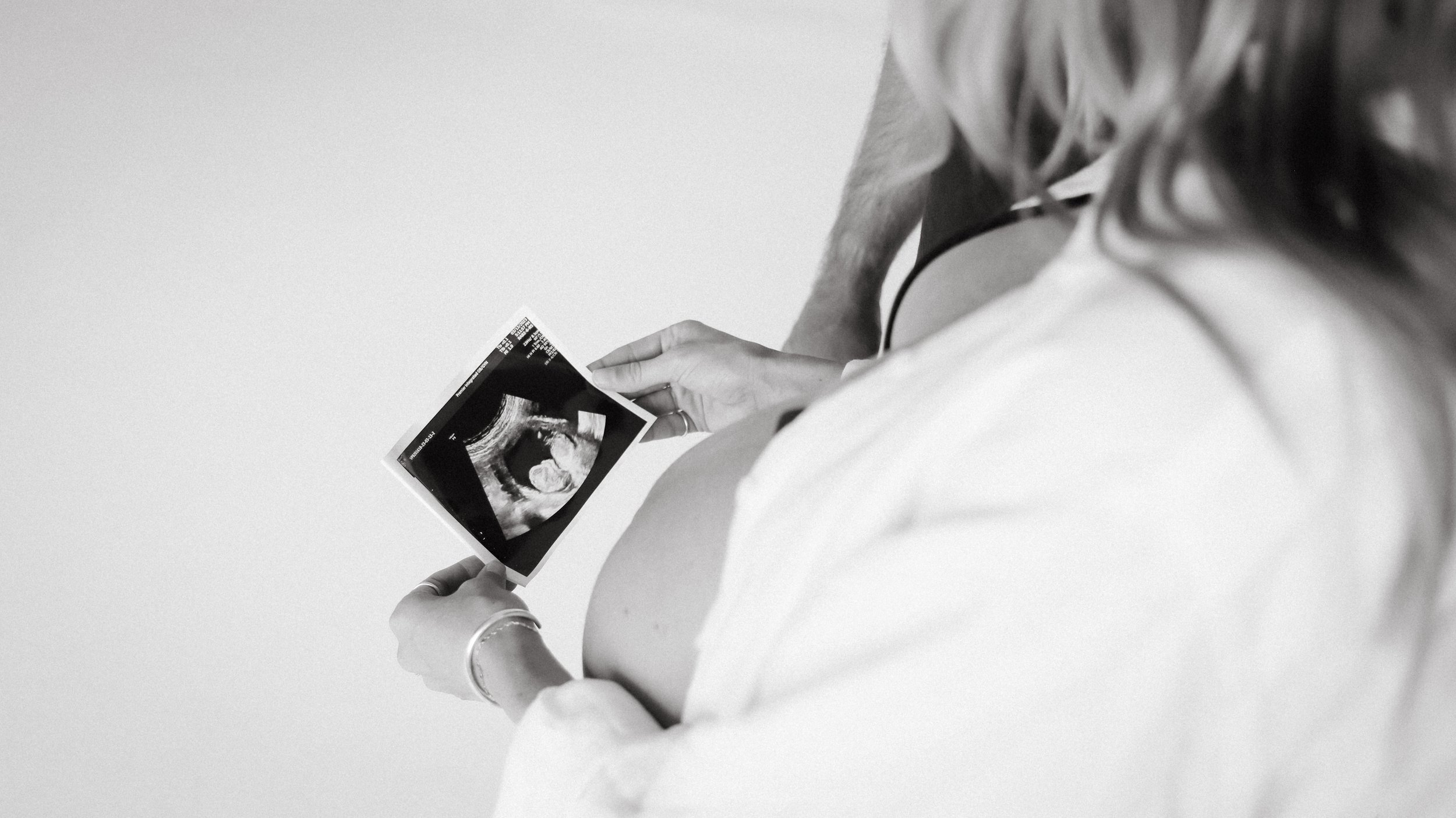 Celebrate the Middleton's journey into parenthood with stunning maternity photography at Realm Studio in Denver, CO, expertly captured by Nicole Schmiedl.