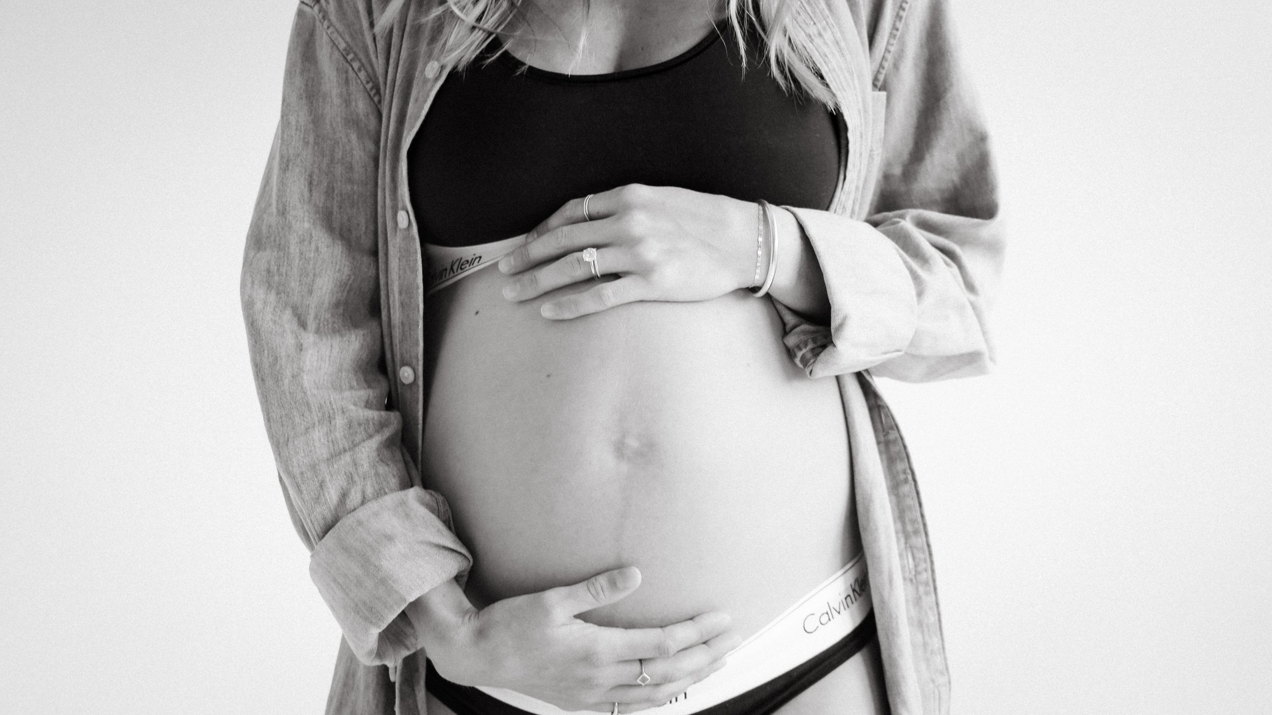 Celebrate the Middleton's journey into parenthood with stunning maternity photography at Realm Studio in Denver, CO, expertly captured by Nicole Schmiedl.