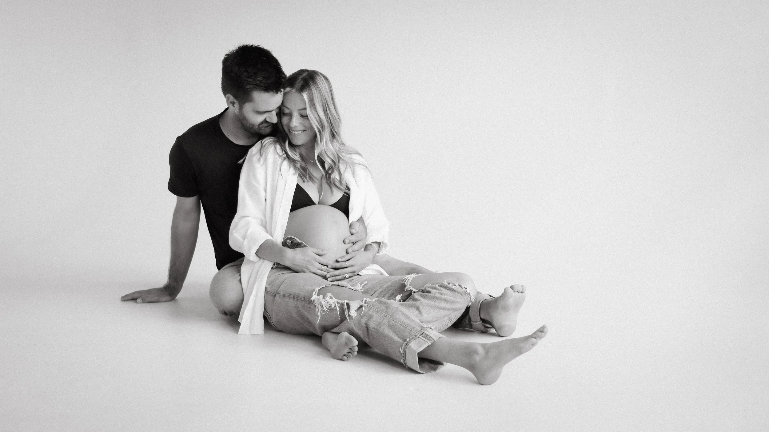 Celebrate the Middleton's journey into parenthood with stunning maternity photography at Realm Studio in Denver, CO, expertly captured by Nicole Schmiedl.