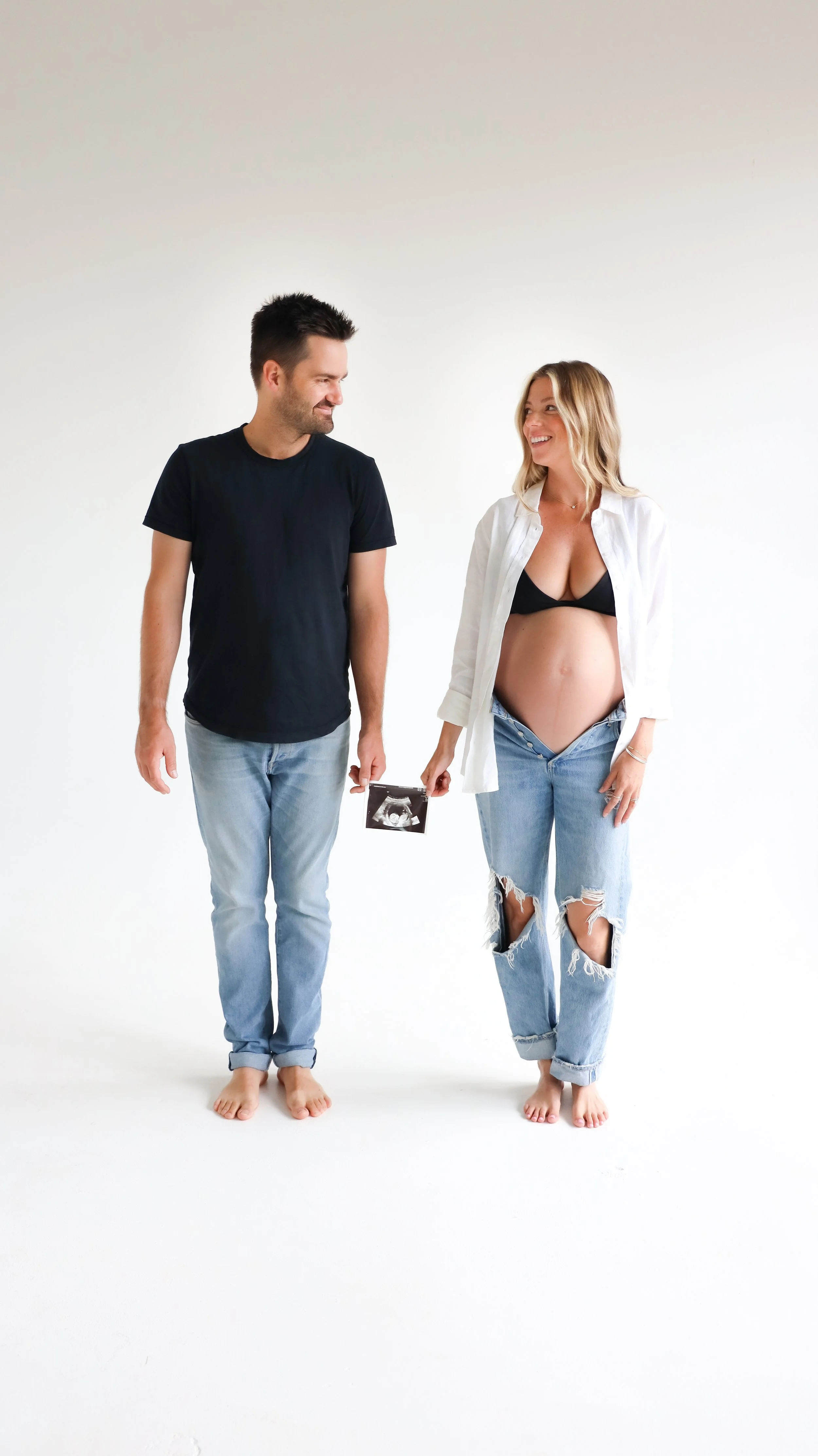 Celebrate the Middleton's journey into parenthood with stunning maternity photography at Realm Studio in Denver, CO, expertly captured by Nicole Schmiedl.