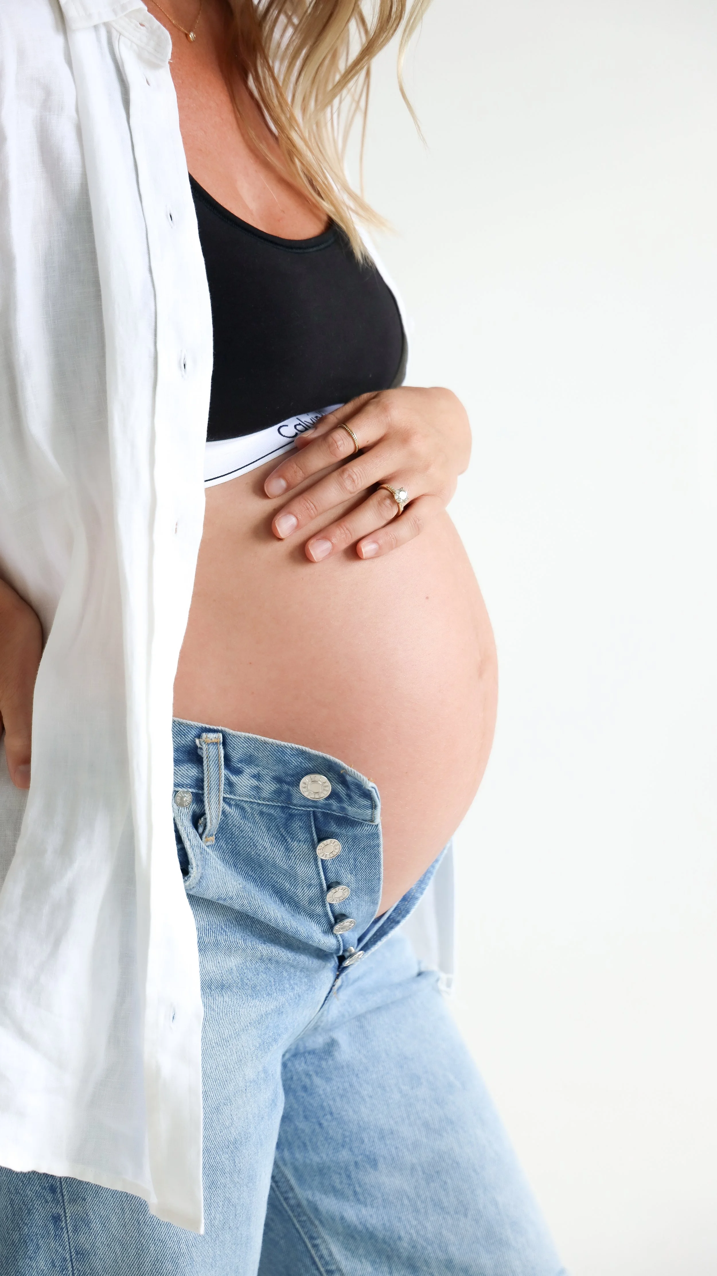 Celebrate the Middleton's journey into parenthood with stunning maternity photography at Realm Studio in Denver, CO, expertly captured by Nicole Schmiedl.