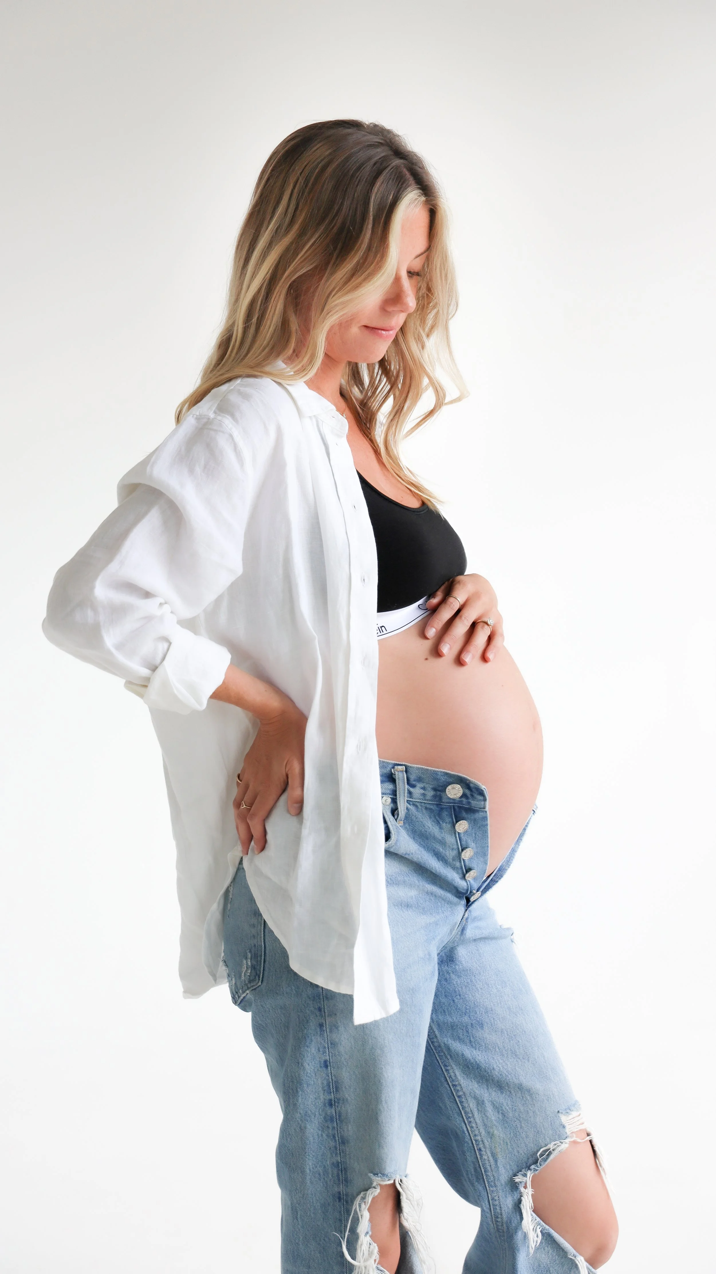 Celebrate the Middleton's journey into parenthood with stunning maternity photography at Realm Studio in Denver, CO, expertly captured by Nicole Schmiedl.