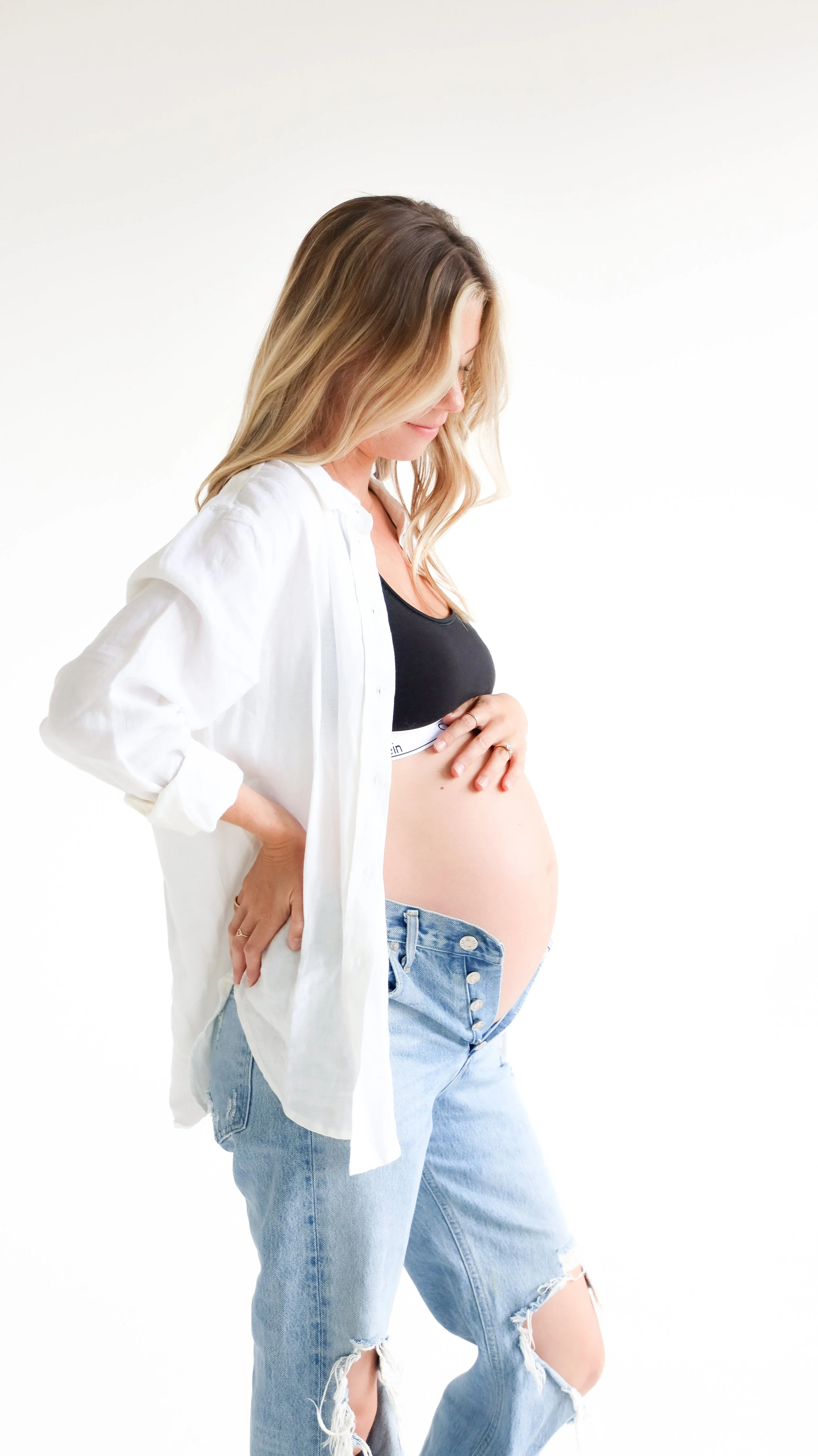 Celebrate the Middleton's journey into parenthood with stunning maternity photography at Realm Studio in Denver, CO, expertly captured by Nicole Schmiedl.