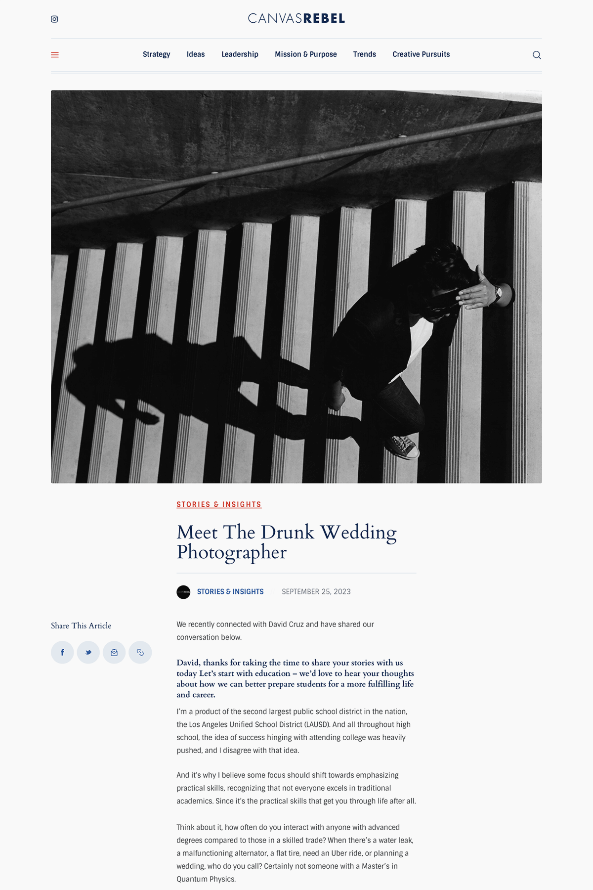 A person viewed from above, walking down stairs with striped steps, casting a shadow on the stairs, while covering their forehead with one hand.