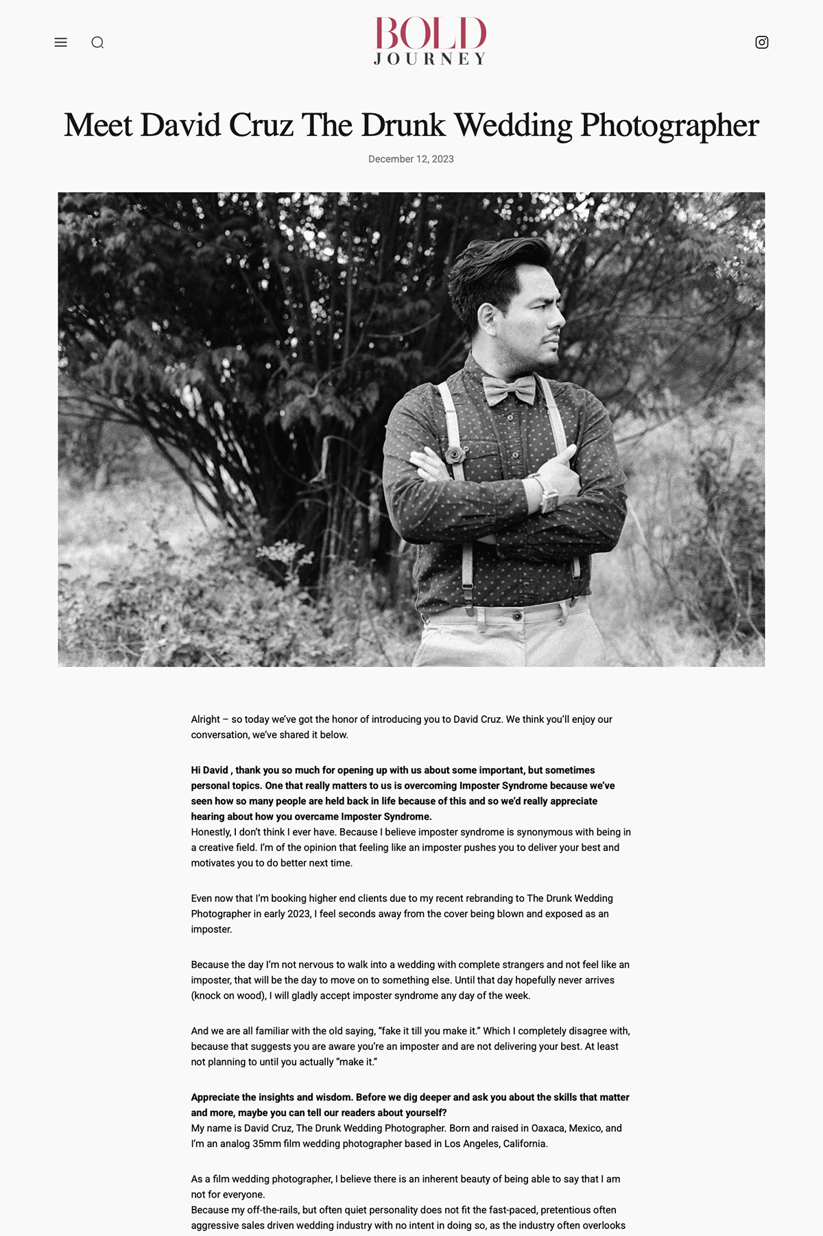 Article webpage titled "Meet David Cruz The Drunk Wedding Photographer," featuring a black-and-white photo of a man standing outdoors with arms crossed, wearing suspenders, a shirt, and a bow tie, with a large bush in the background.