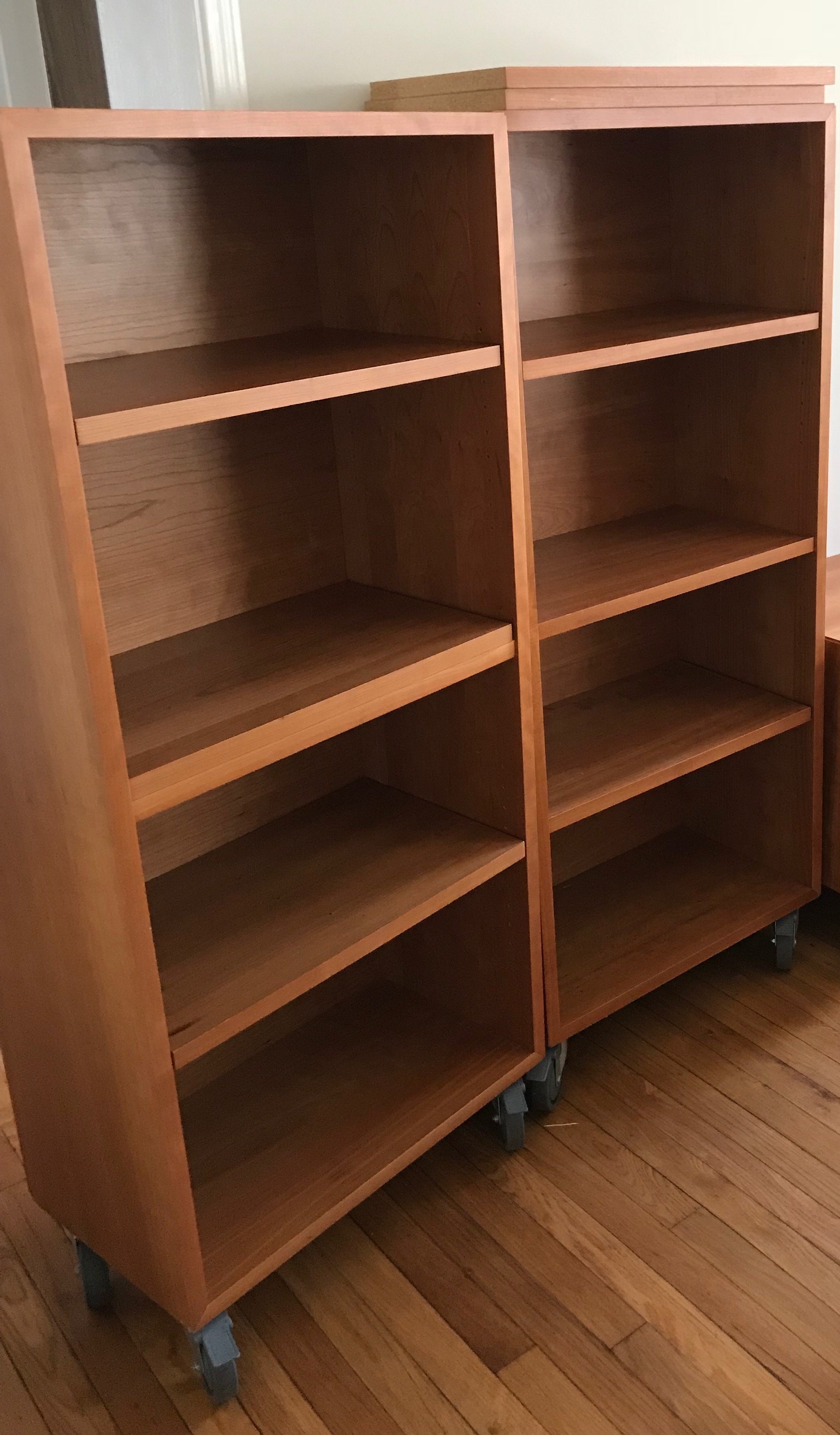 room and board cherry copenhagen bookcases 25" on casters. worn, loved, moved, and still going. plus extra shelves purchased by room and board.