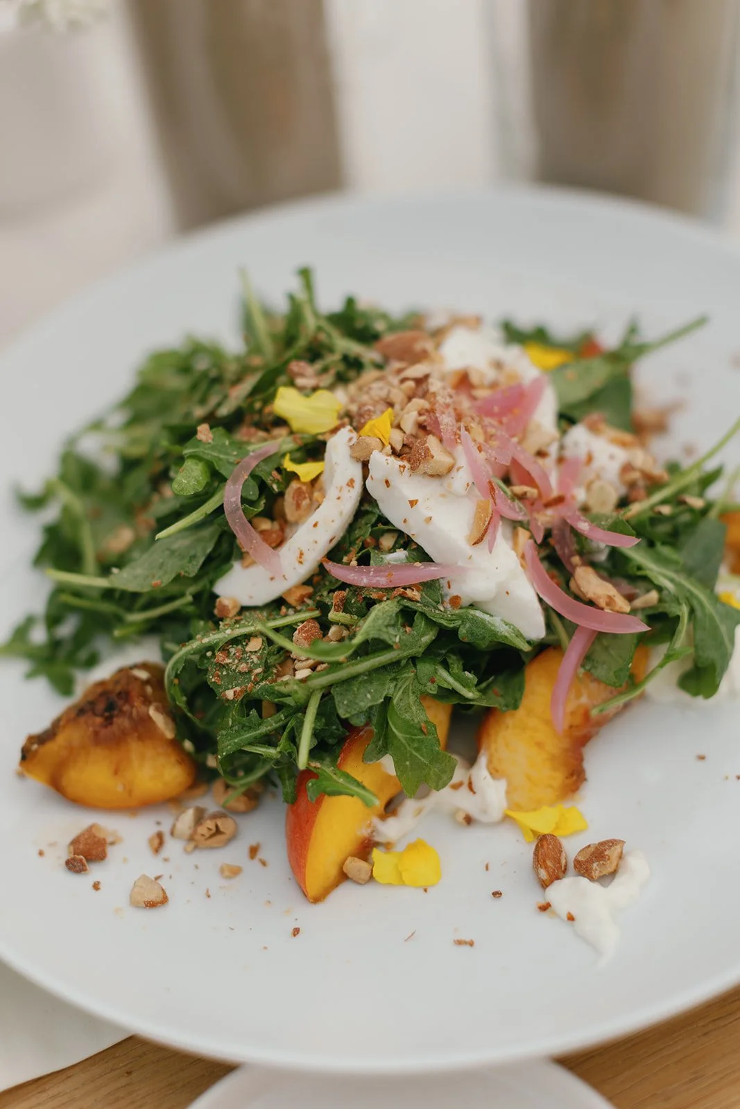 Better when shared.

Family-style grilled peach &amp; burrata with toasted almonds, arugula, shaved pickled red onion, red wine vinaigrette.

Photography: @kellybrownweddings

#UnforgettableWeddings #GuestExperience #ElevateYourEvent #CateringInnovat
