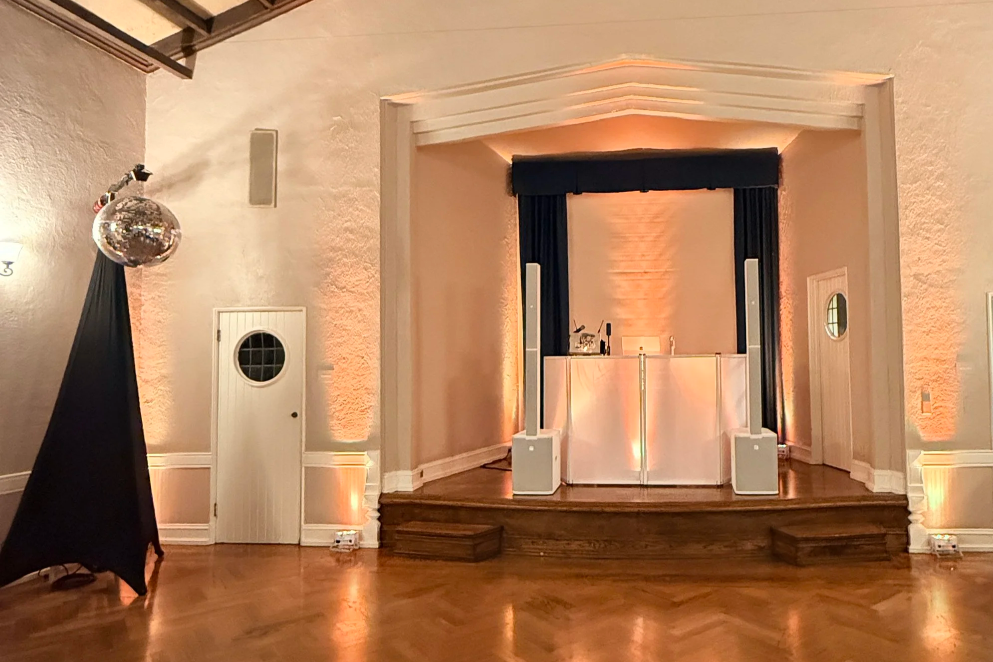 Fog City DJ booth with vibrant disco-style lighting at a wedding reception.