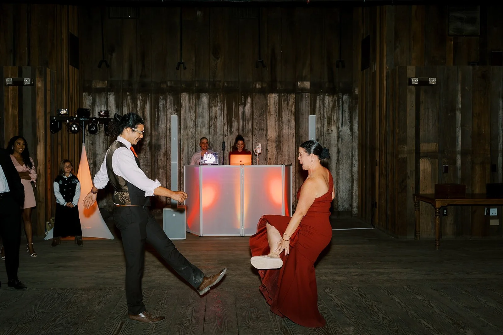 Wedding guests performing on the dance floor during a fun DJ-led reception