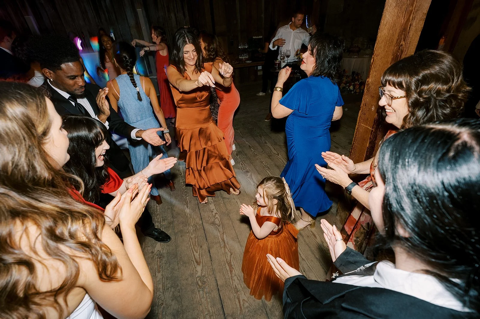 Packed wedding dance floor with guests of all ages enjoying a balanced wedding tracklist